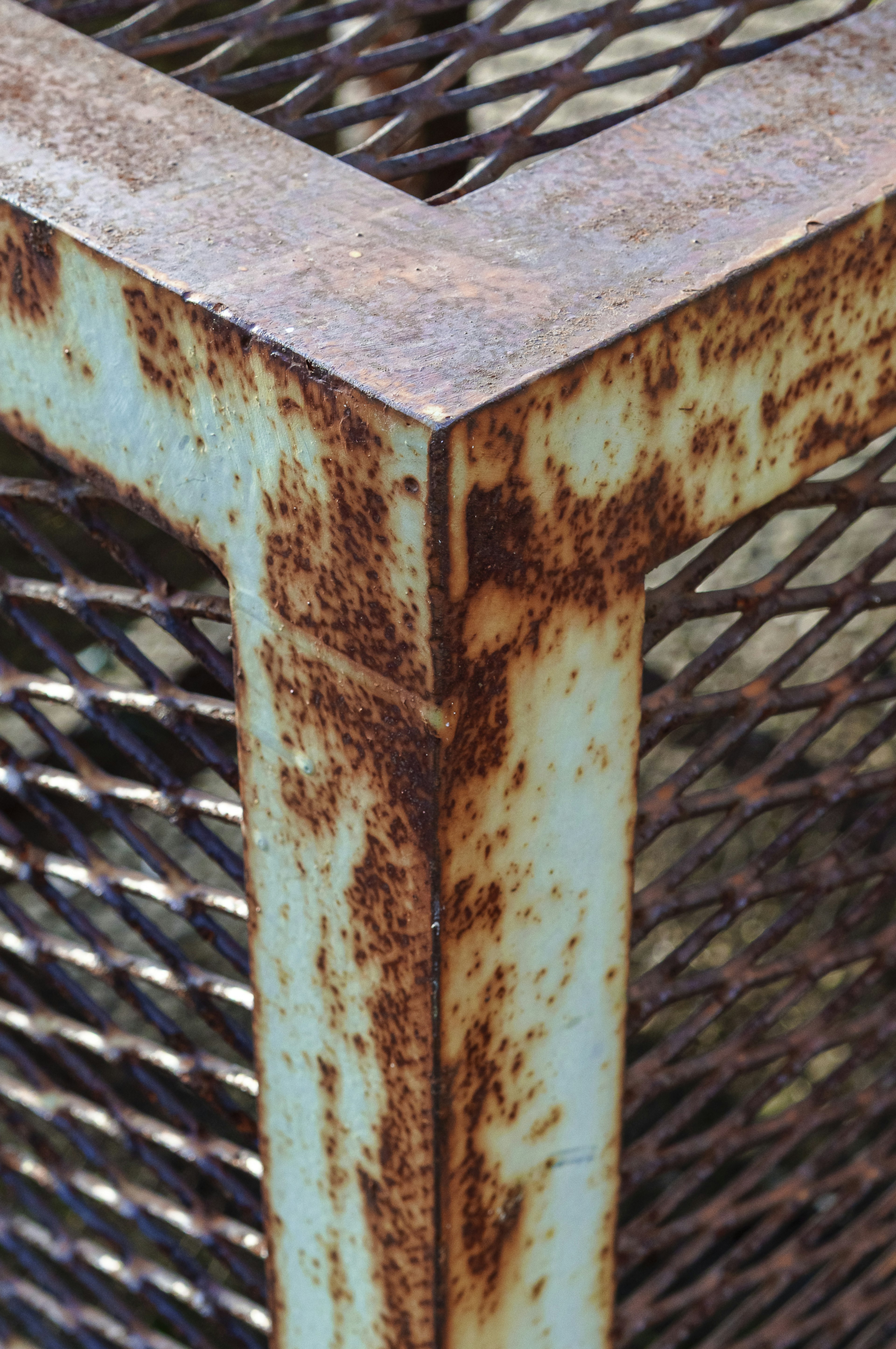 Rusty metal corner with mesh structure details