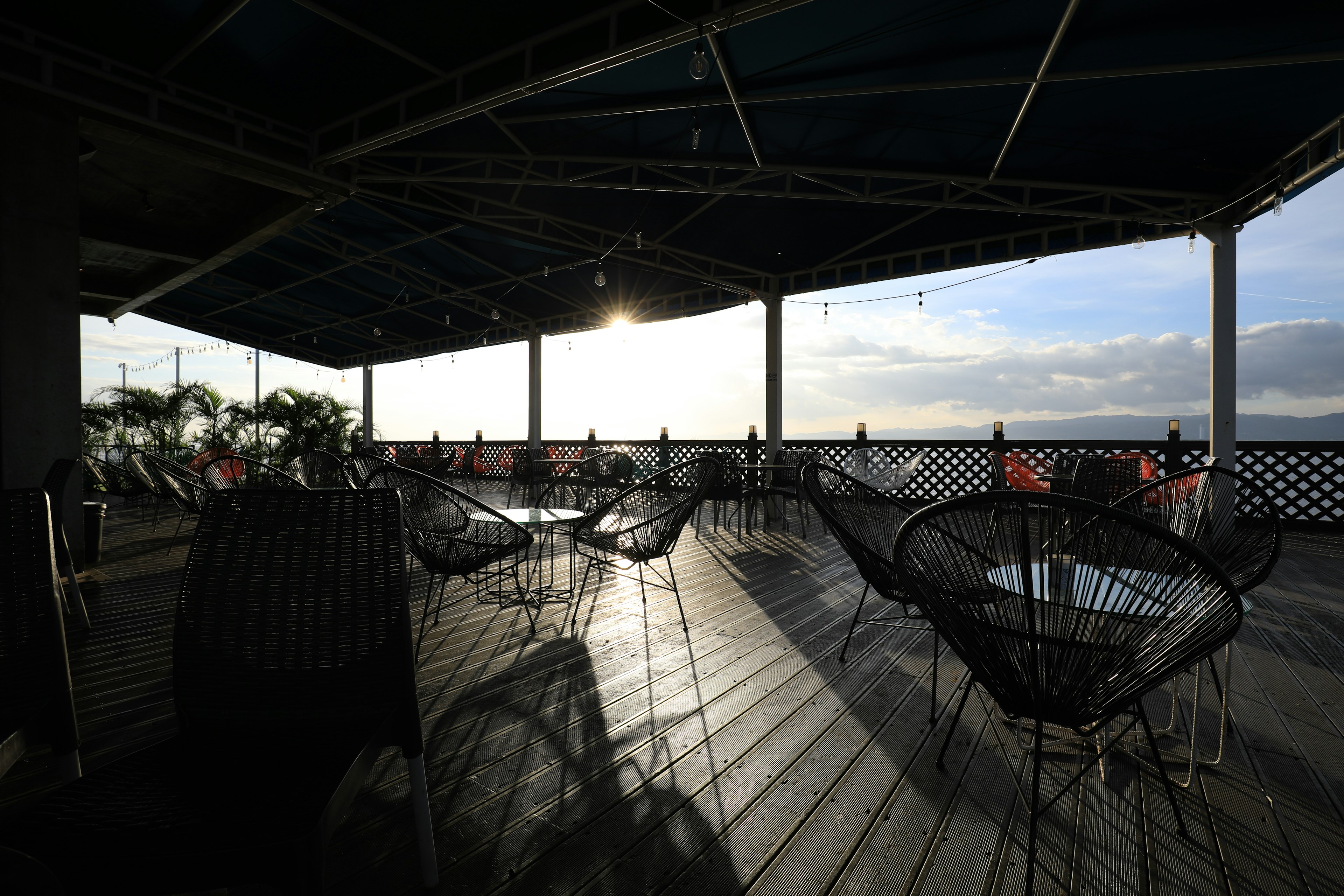 Outdoor terrace with hammocks and sunset view