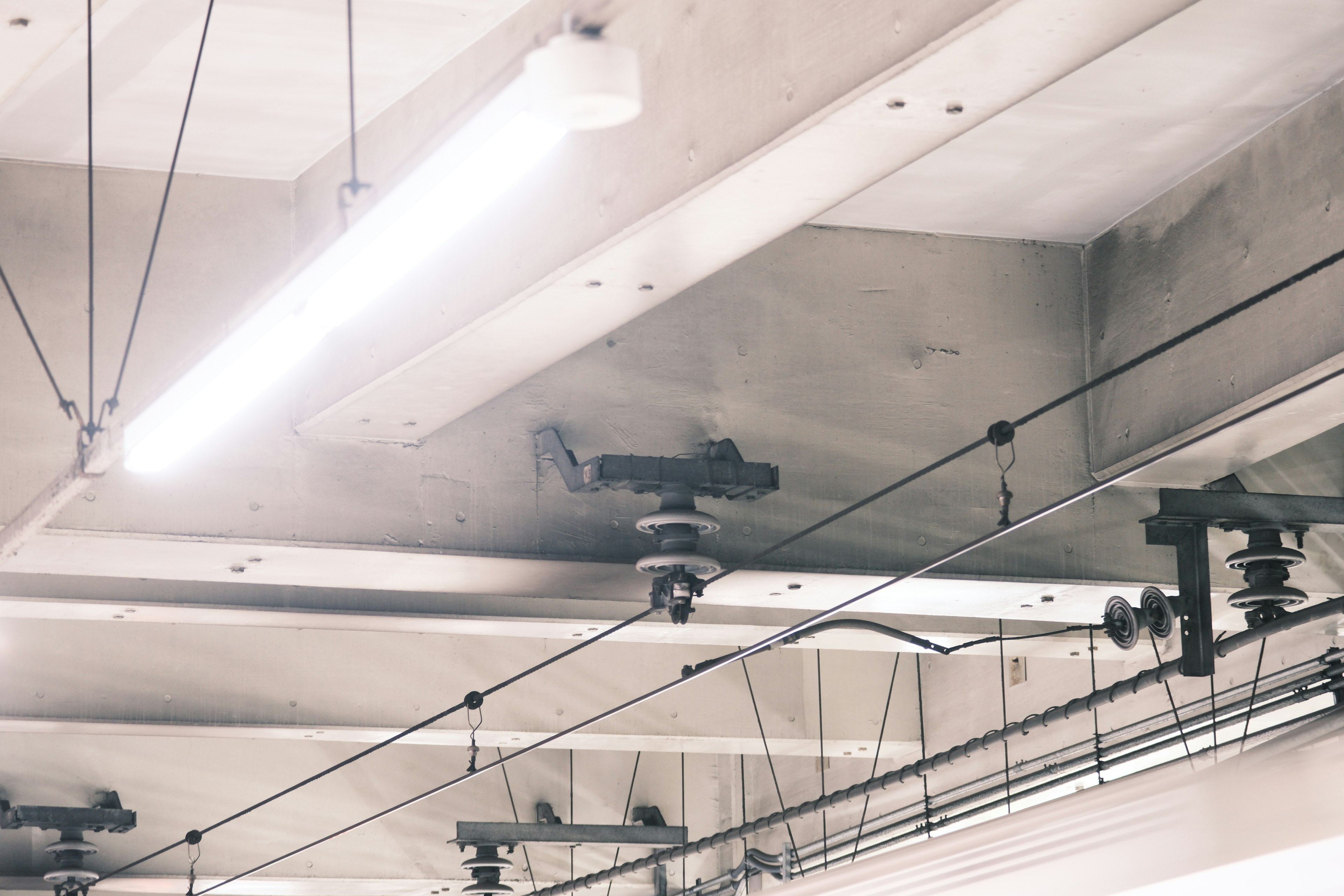 Industrial space with concrete ceiling and bright fluorescent lights