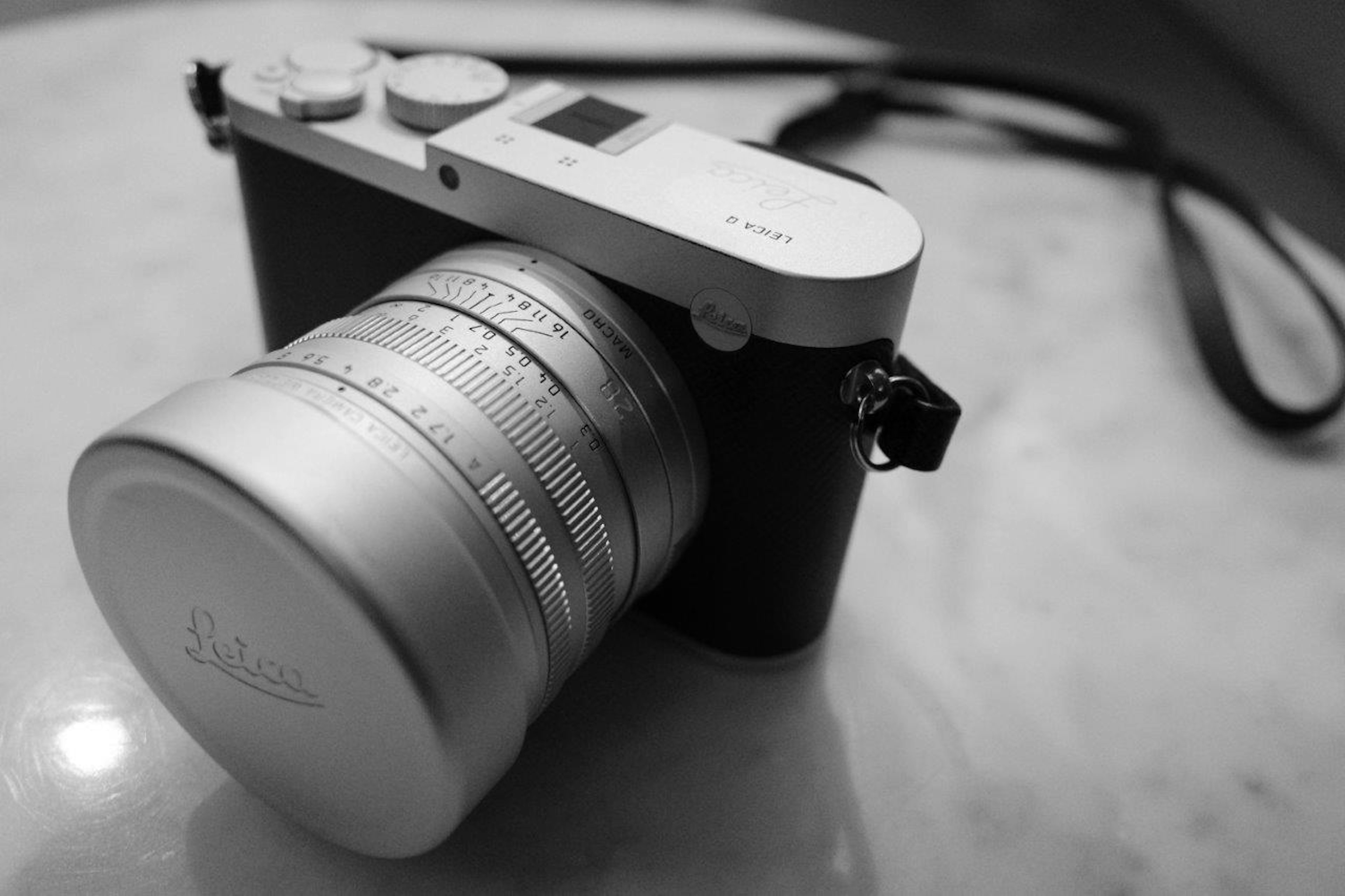 A camera with a silver lens placed on a table