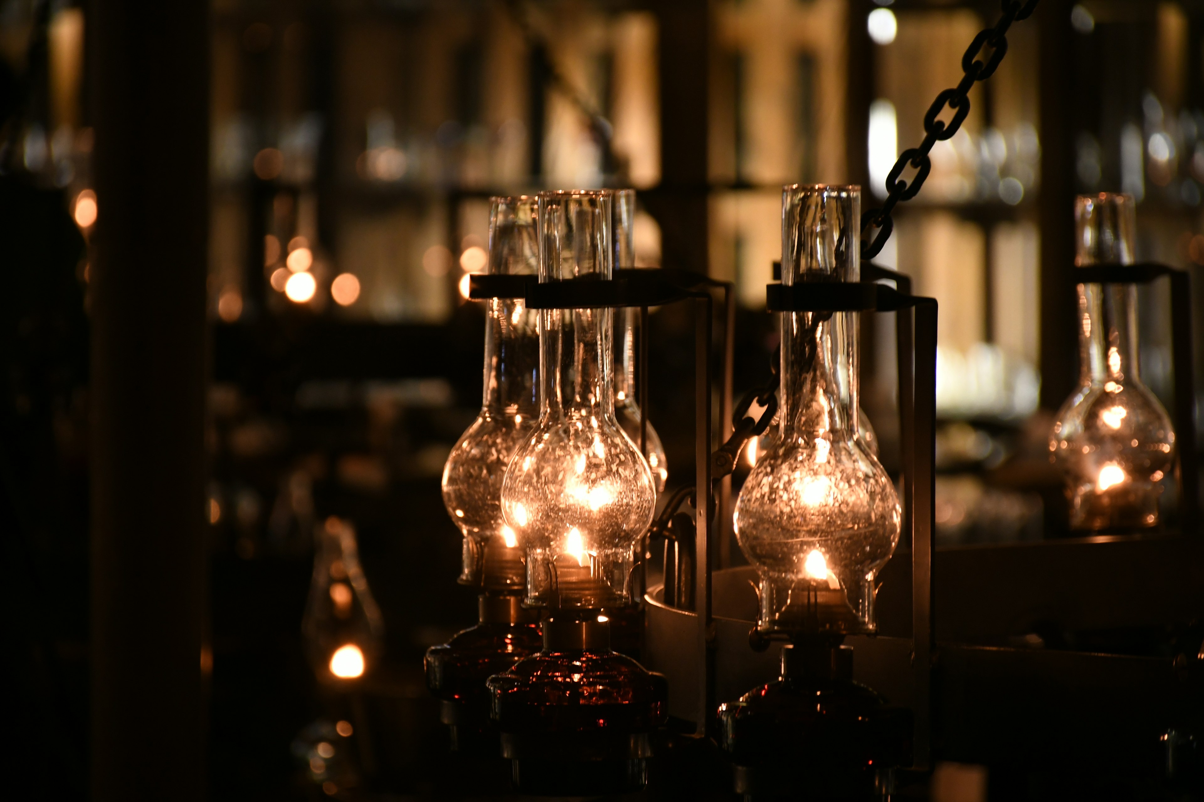 Scene with multiple glass lamps glowing against a dark background