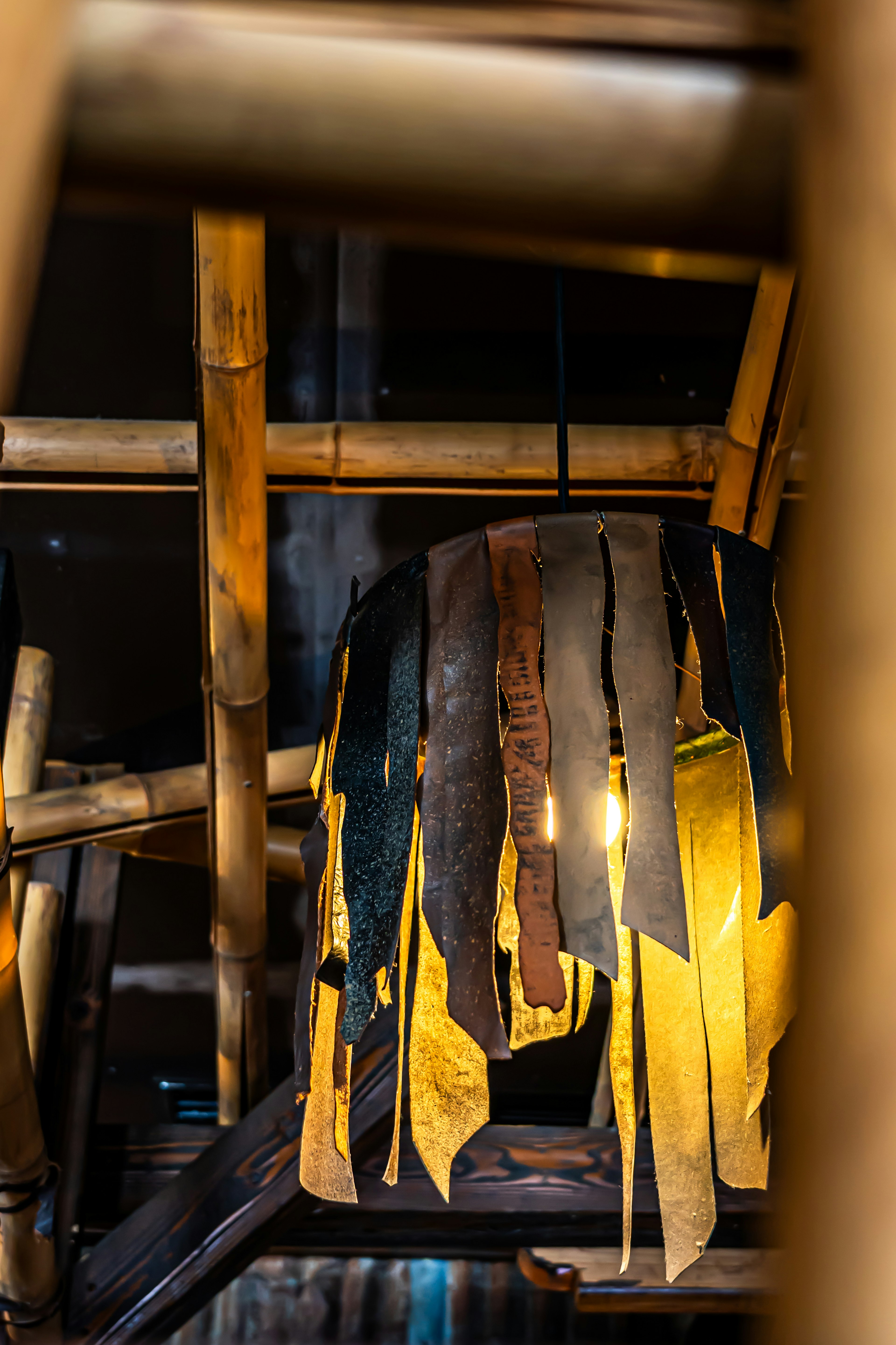 Colorful fabric lampshade hanging in a bamboo interior