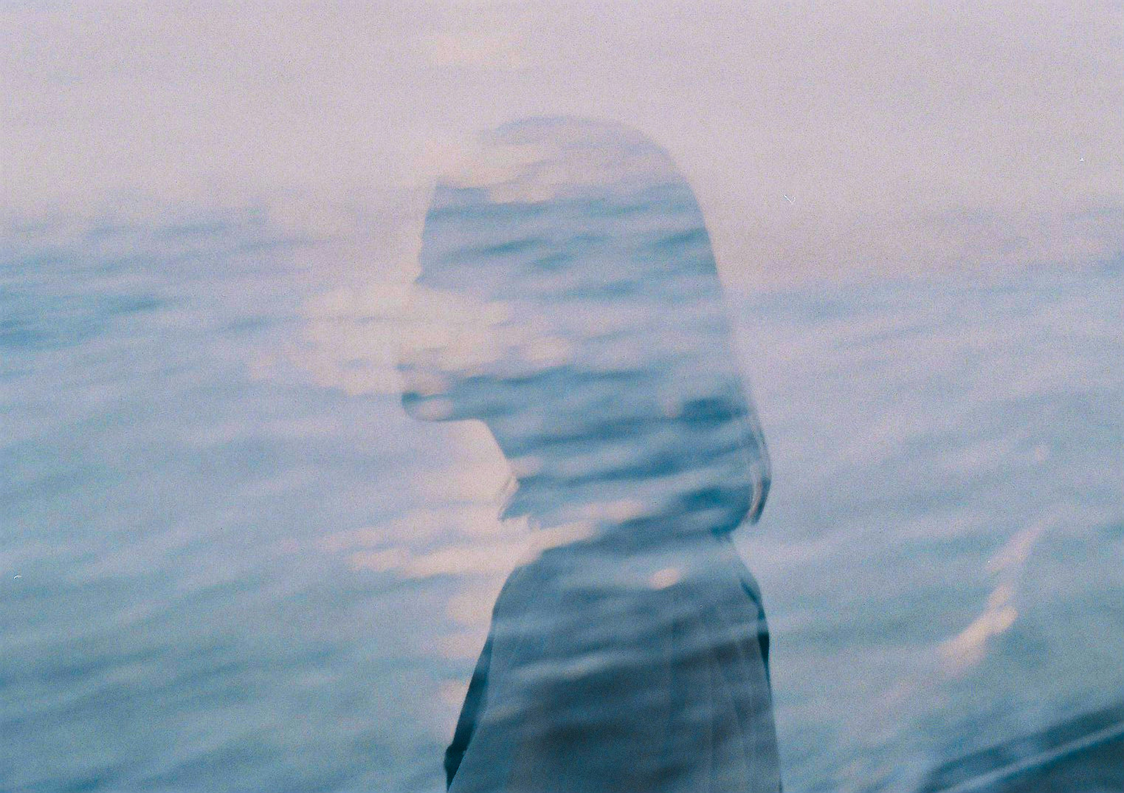 Dreamy scene of a woman's silhouette against a water surface background