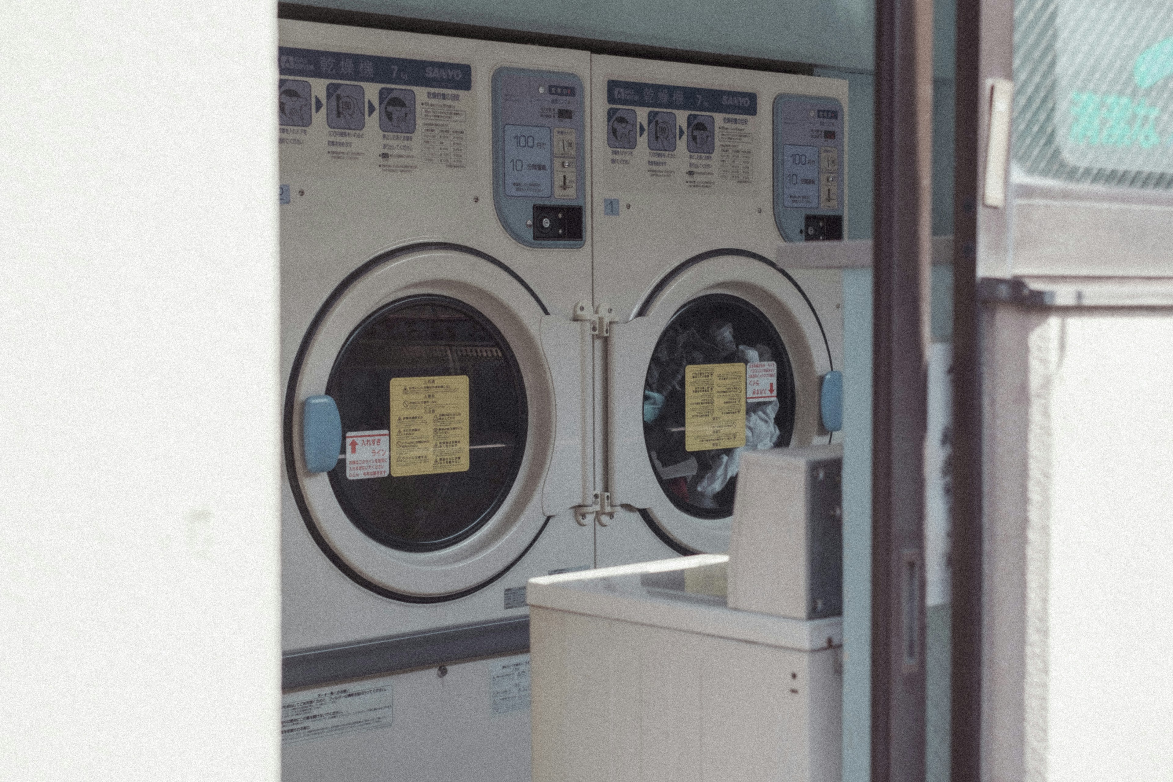 A row of washing machines in a laundry facility