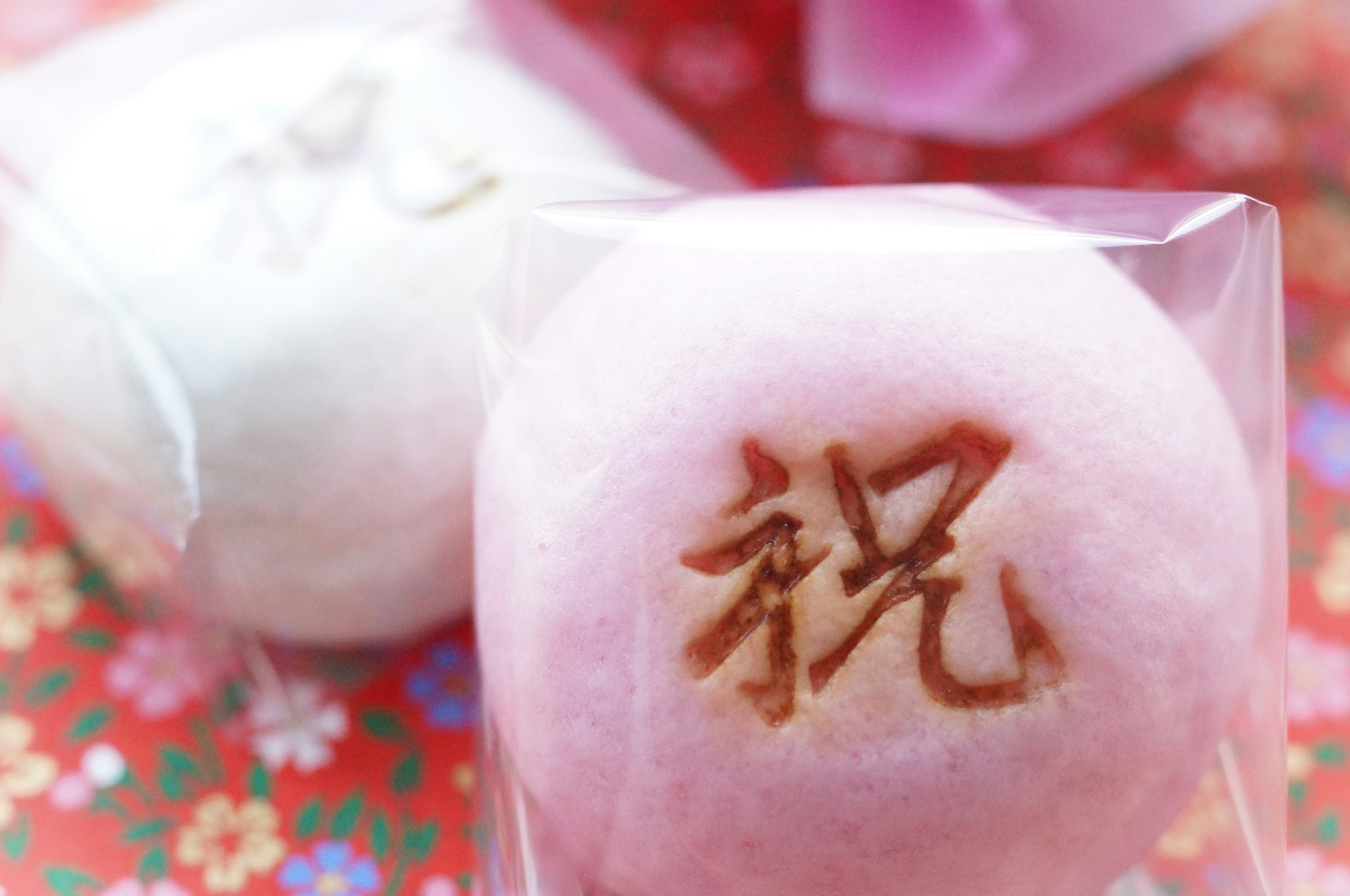 Soft-colored Japanese sweets with the character for celebration engraved