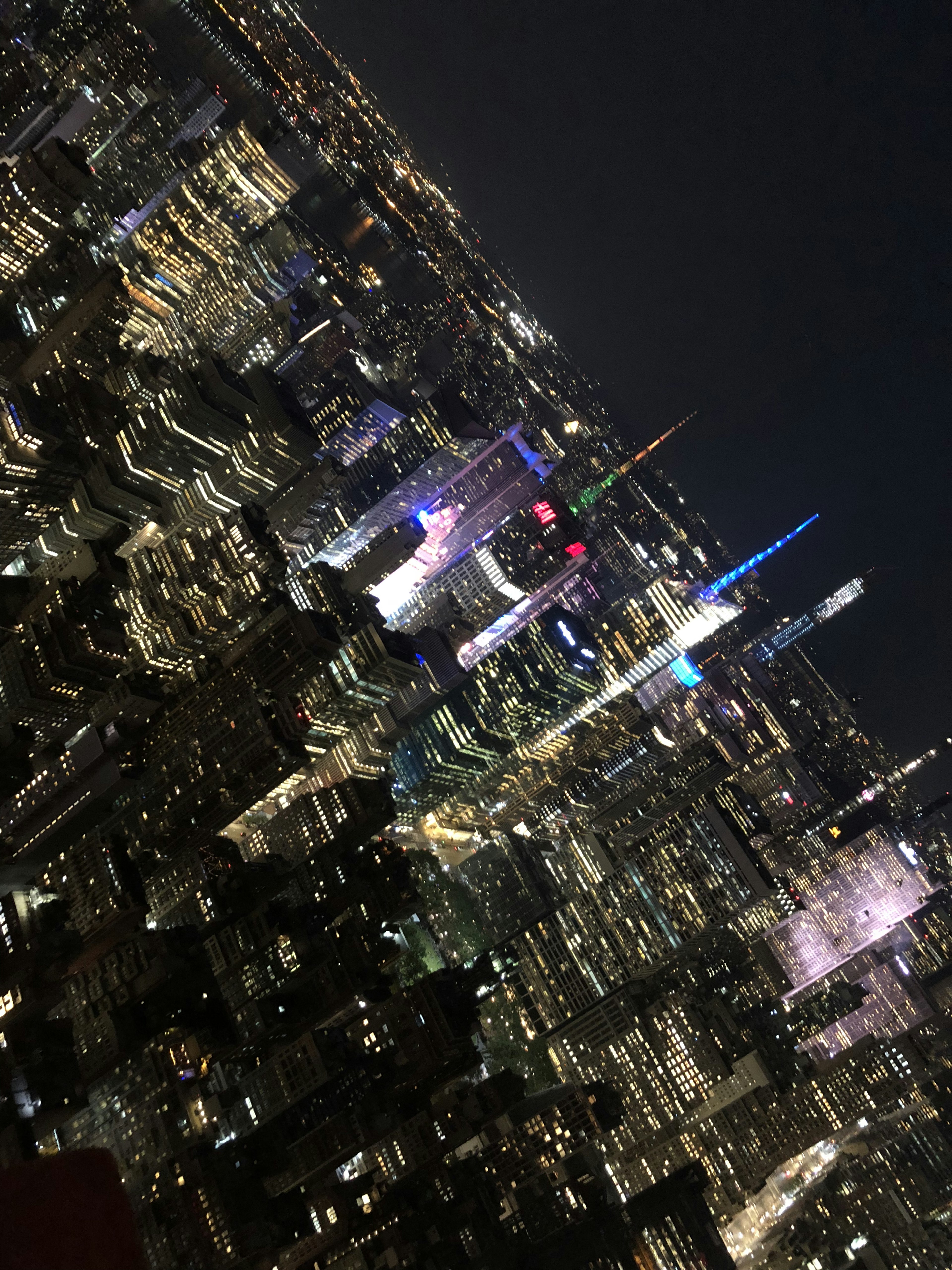 Vue aérienne de la ligne d'horizon de New York la nuit avec des lumières vives