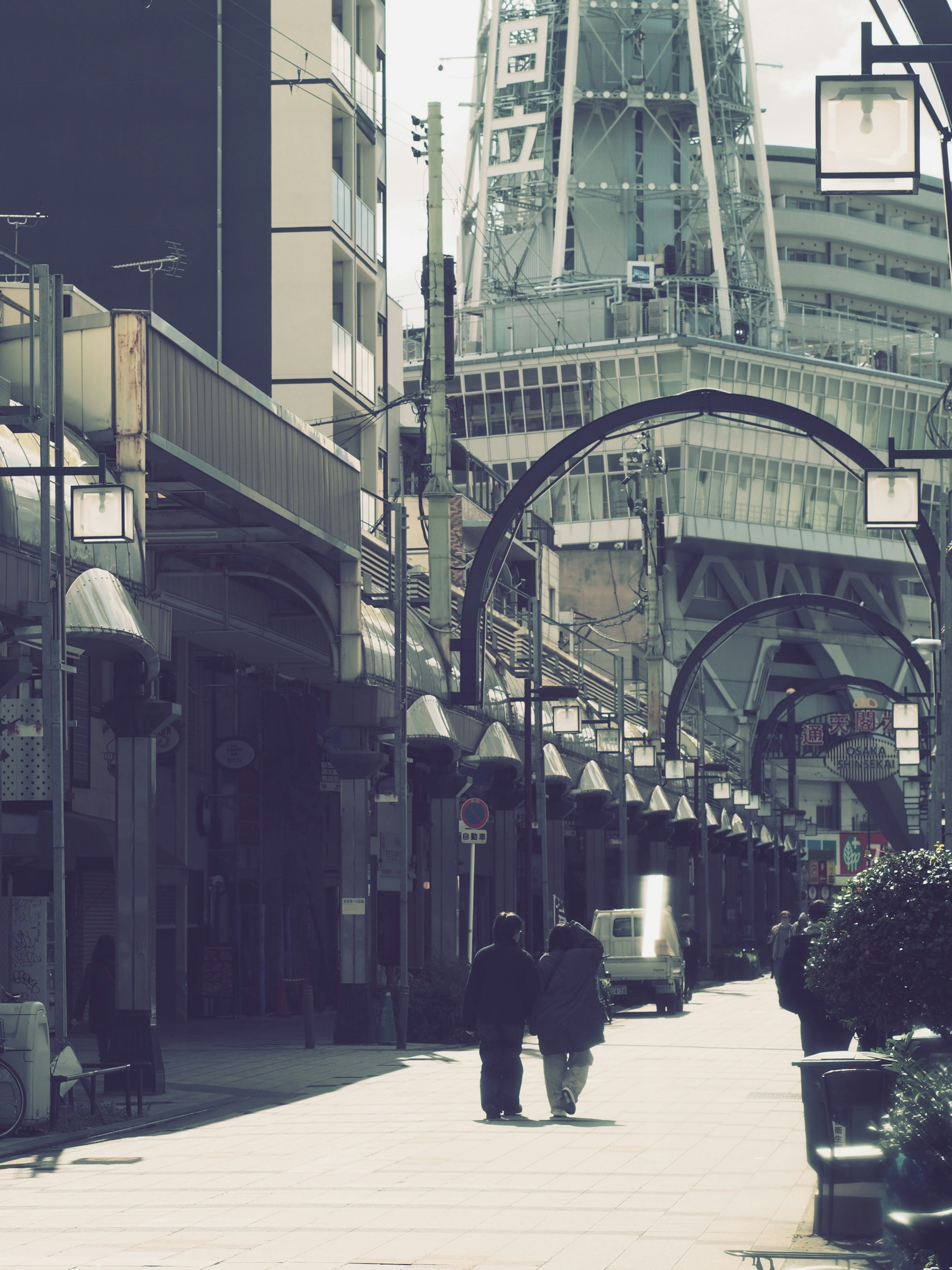 Couple walking in a vibrant shopping street with modern buildings