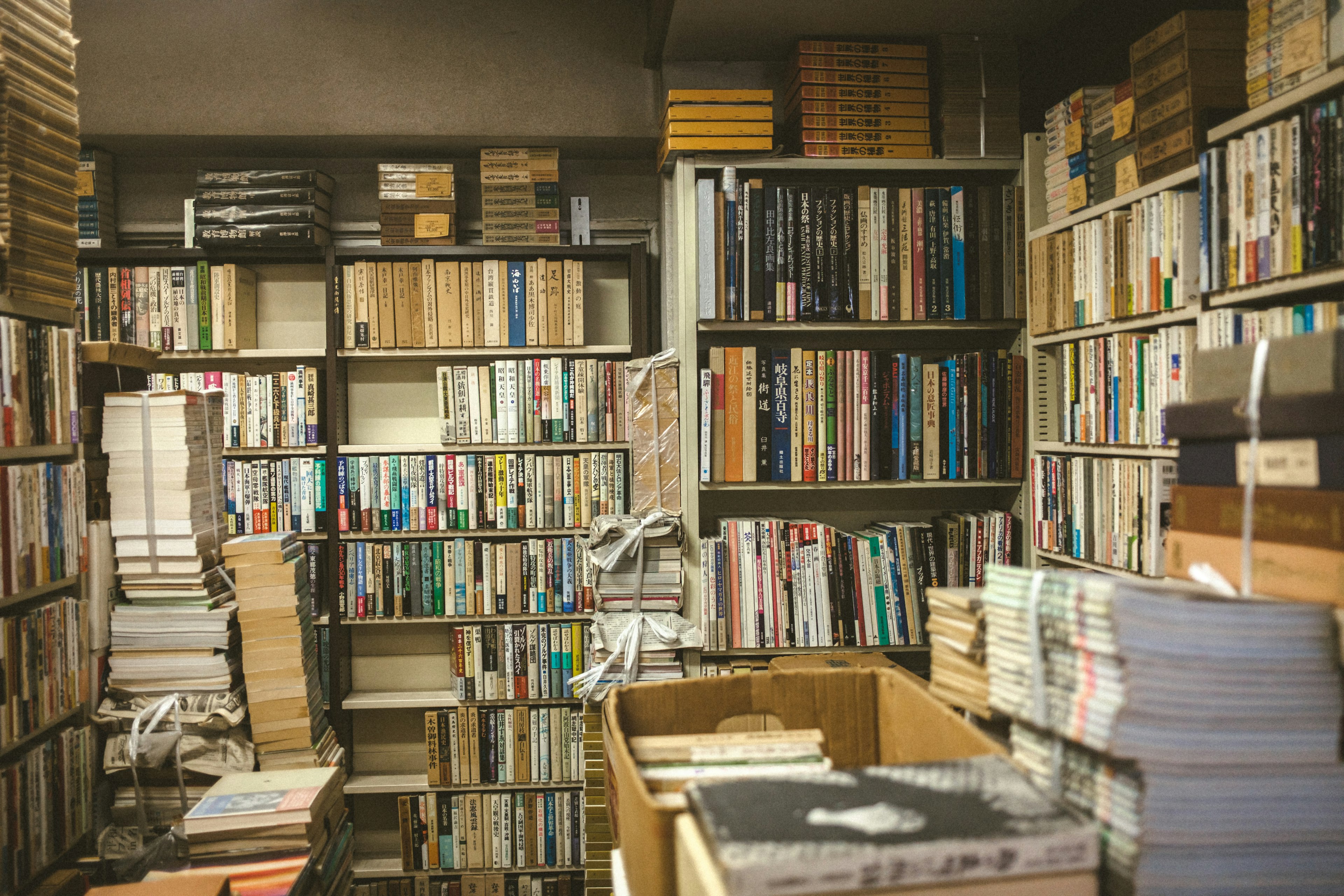 Interior of a narrow room filled with bookshelves stacked with books