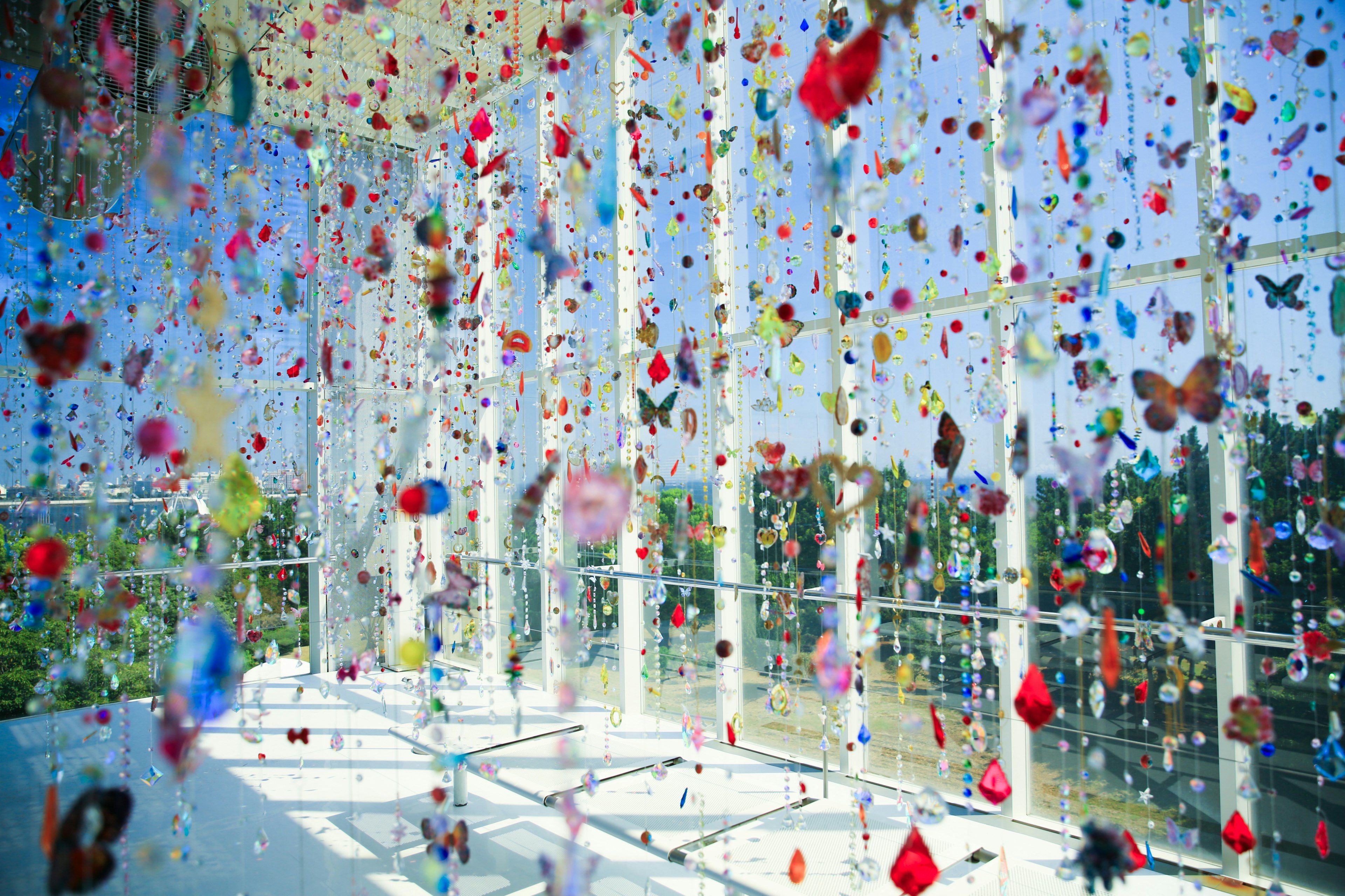 Colorful decorations in a transparent space filled with butterflies and jewel-like objects