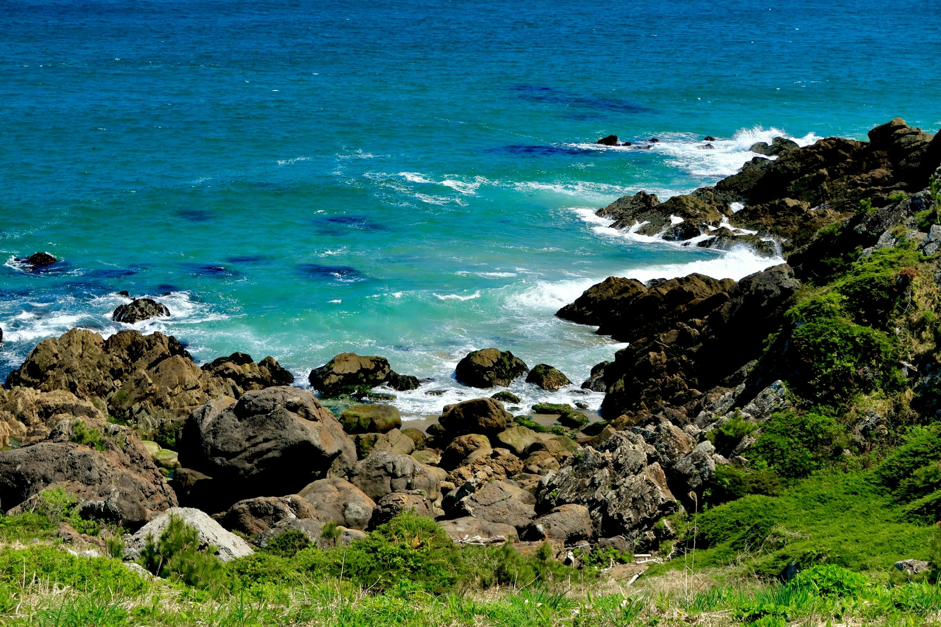 Scenic view of blue ocean and rocky shoreline