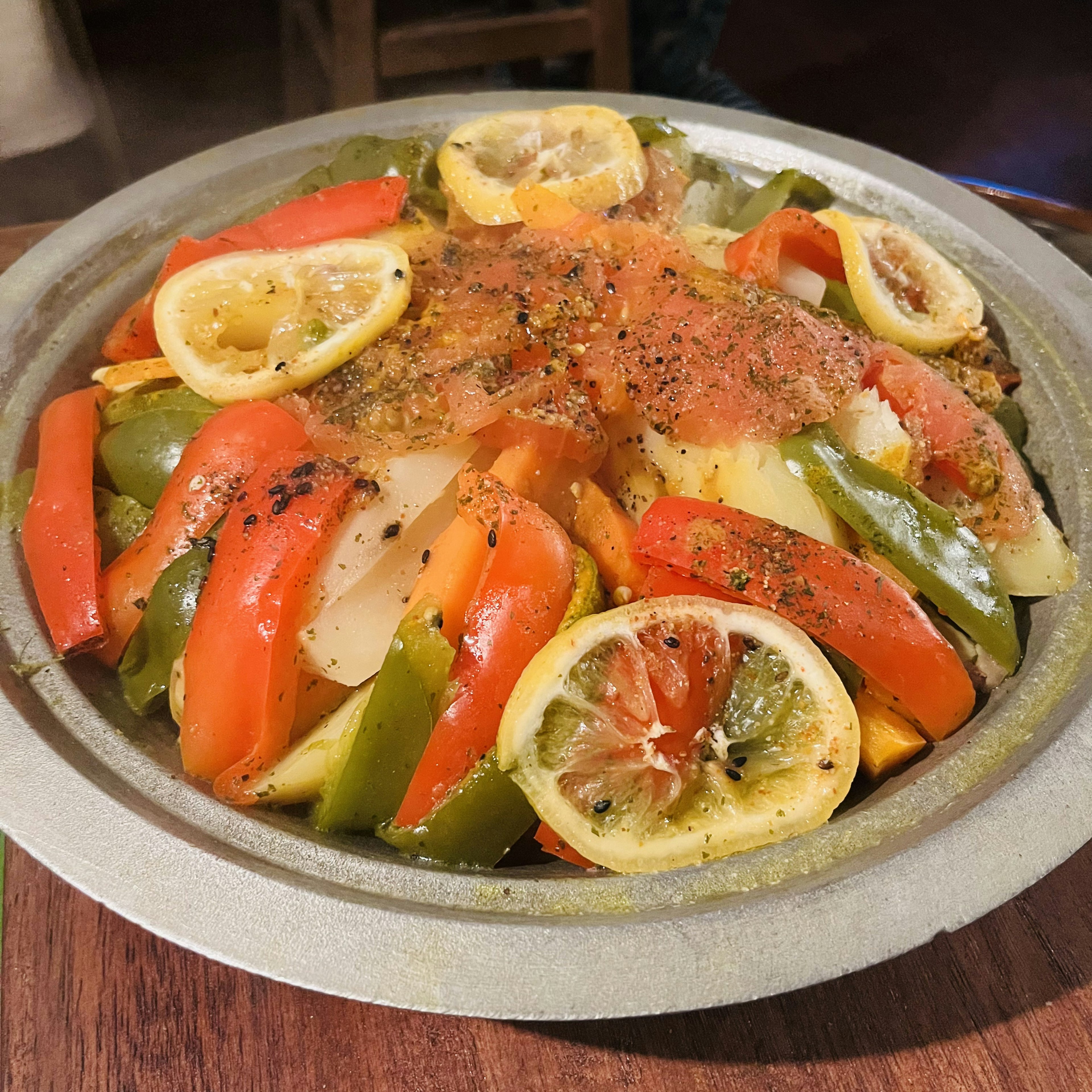 Colorful dish with assorted vegetables and lemon slices on top