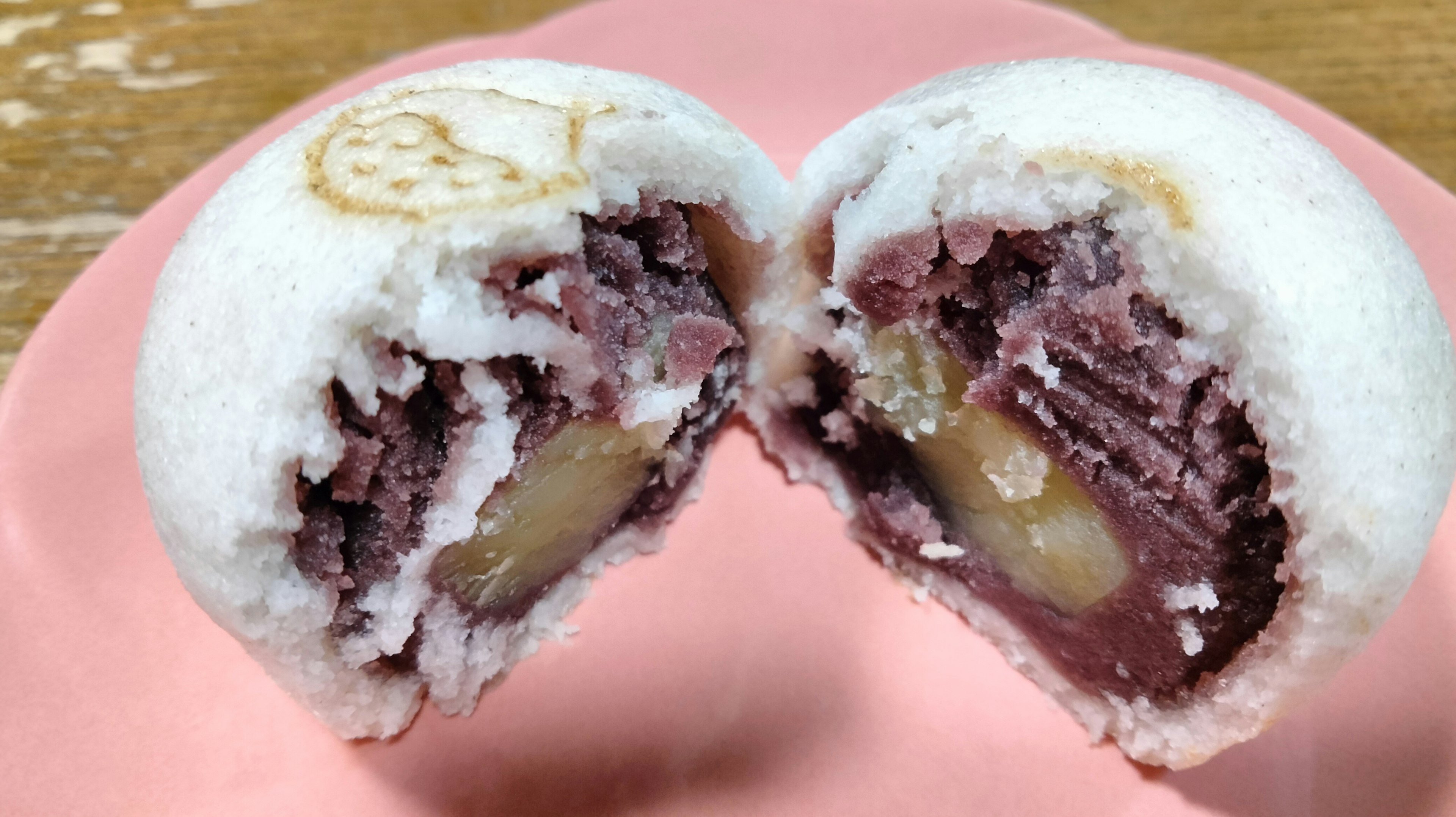 Cross-section of a white bun filled with purple bean paste and chestnut