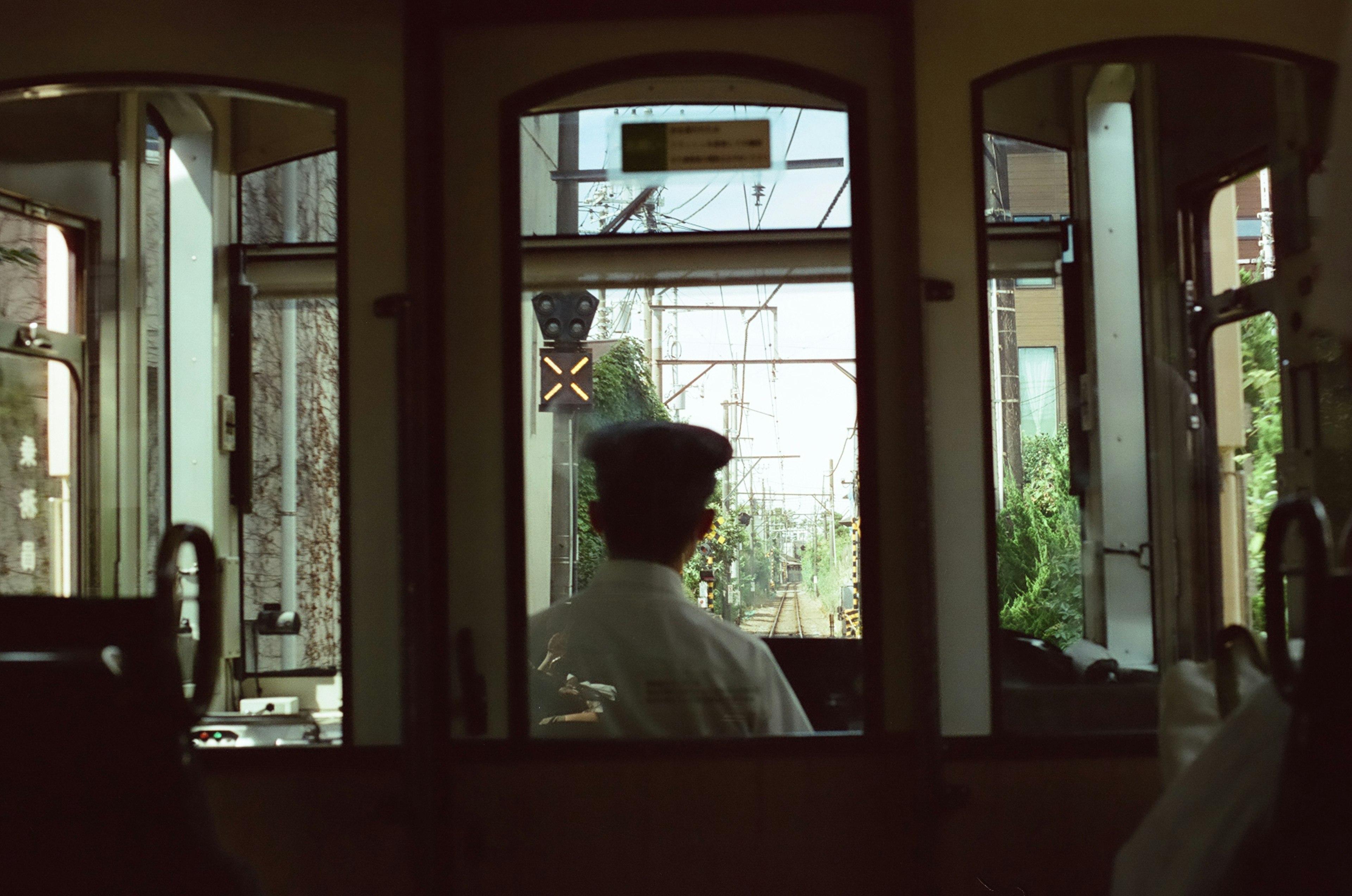 Interior of a tram driver's cabin with the driver facing backward