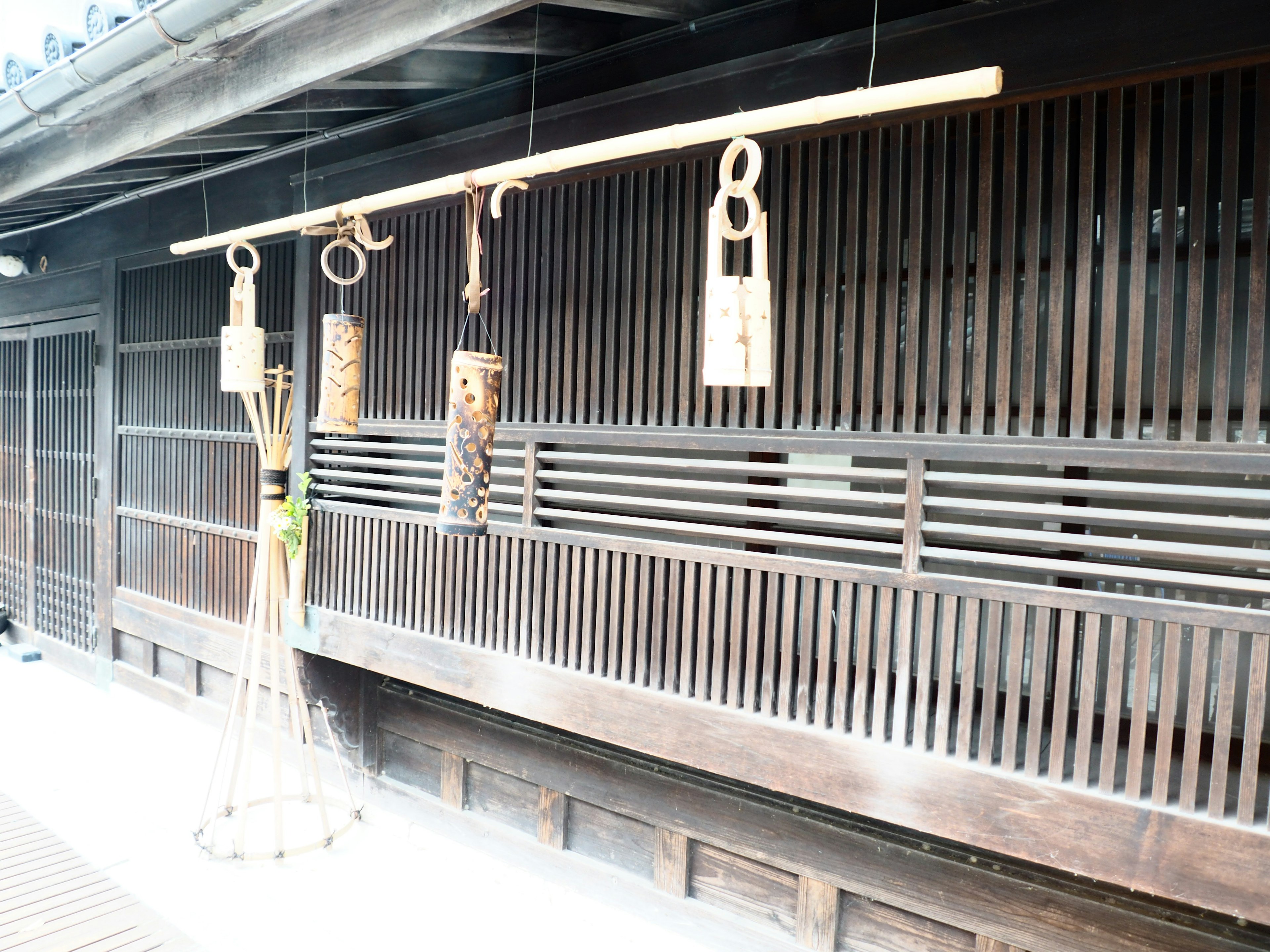 Traditional Japanese wooden wind chimes hanging against a wooden wall