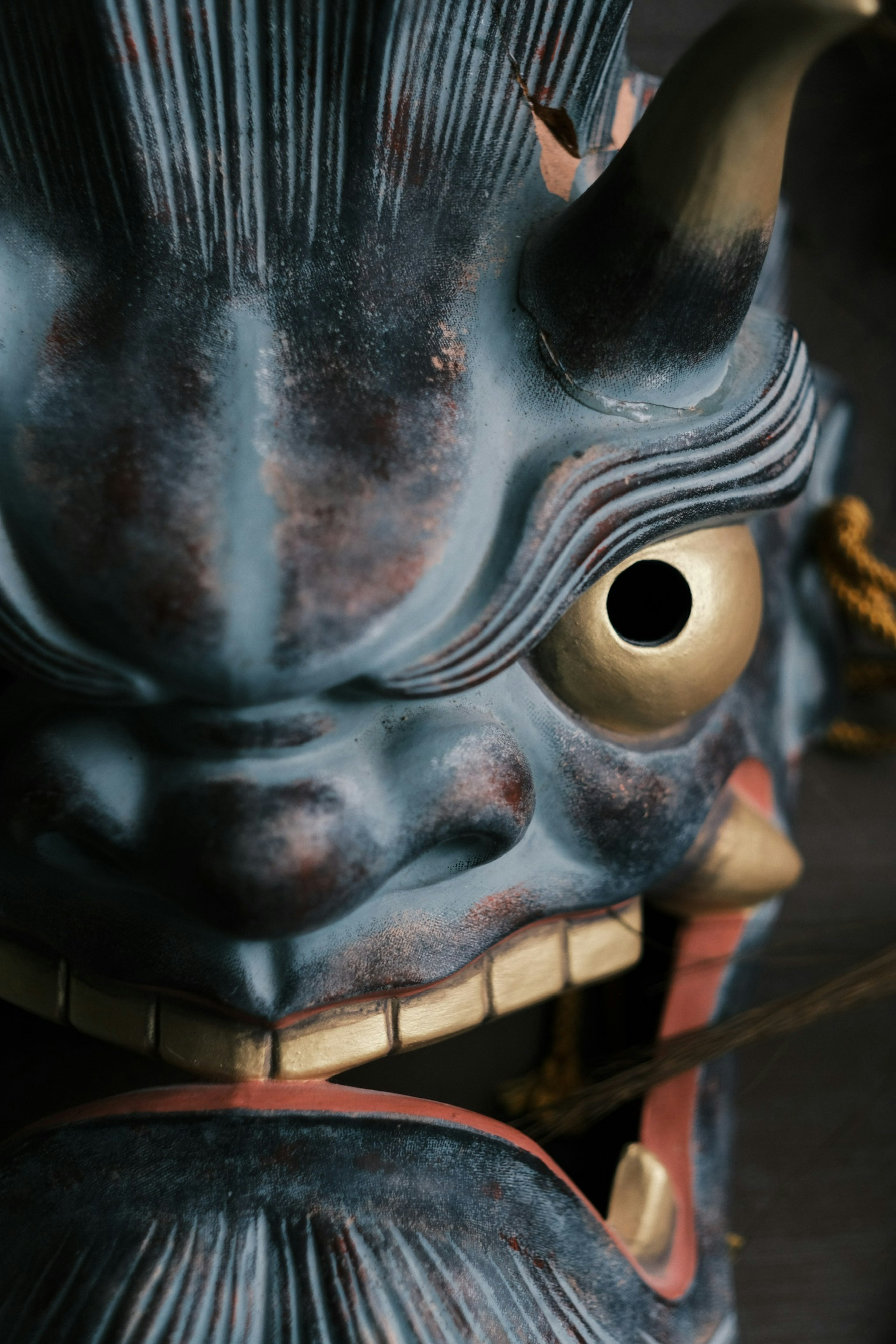 Artistic blue demon mask featuring sharp horns and large eye