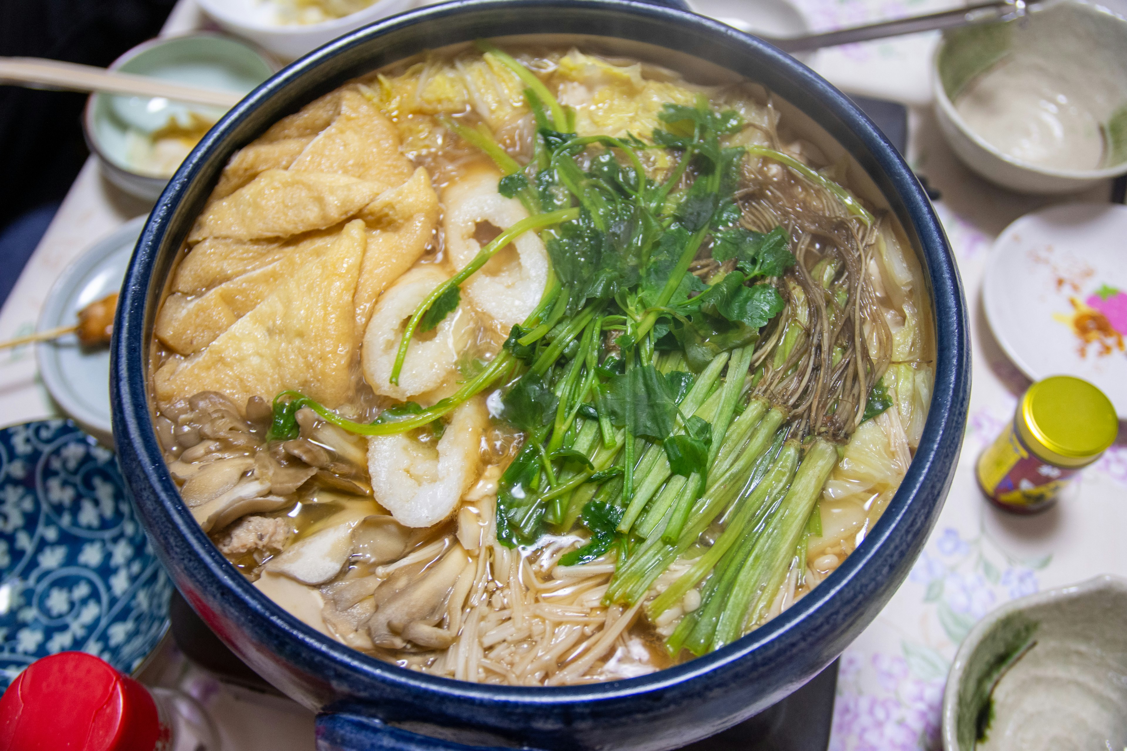 Delicious hot pot filled with green vegetables and tofu