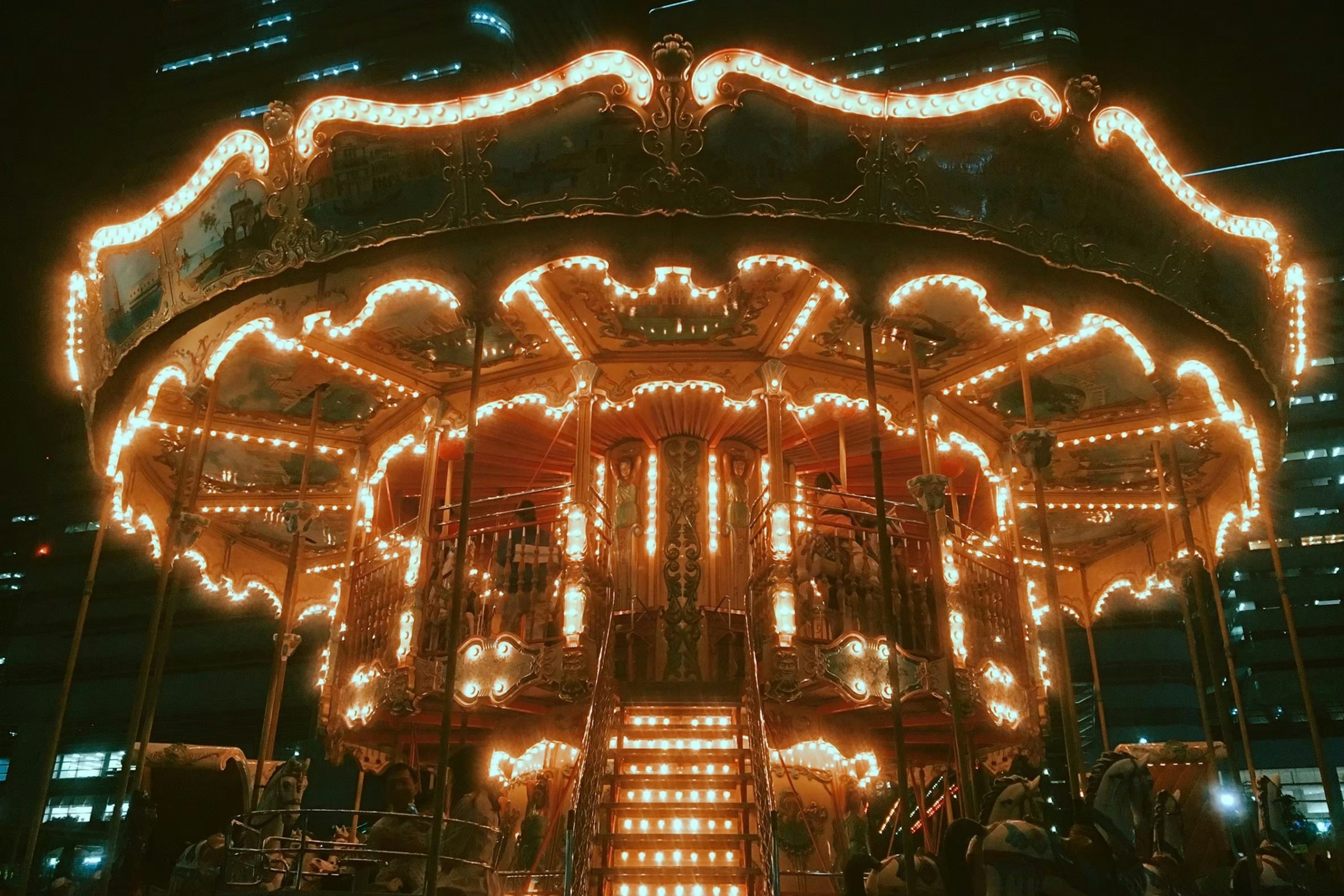 Beautiful carousel illuminated at night in an urban setting