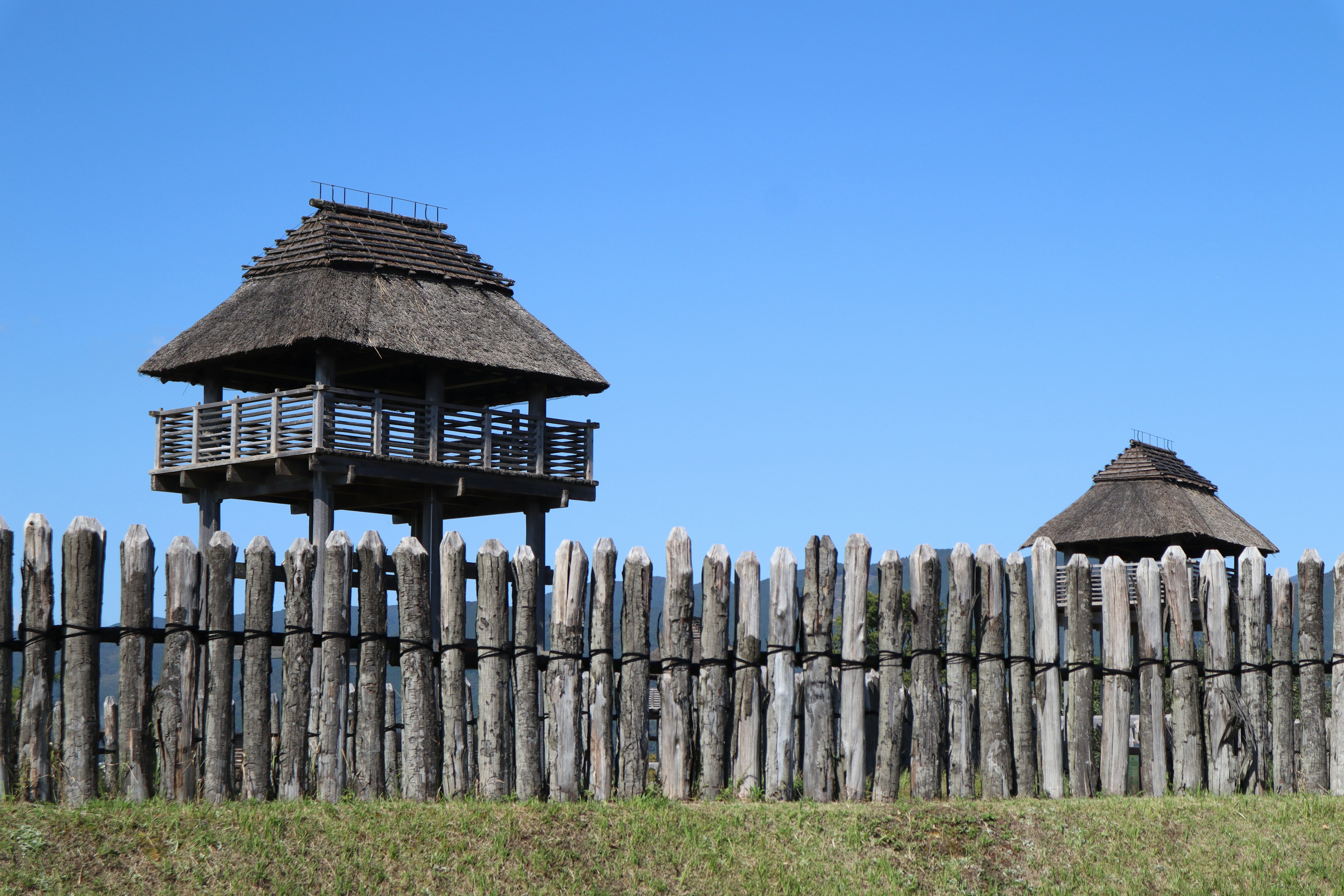 Landschaft mit Holzschutzzaun und zwei Wachtürmen