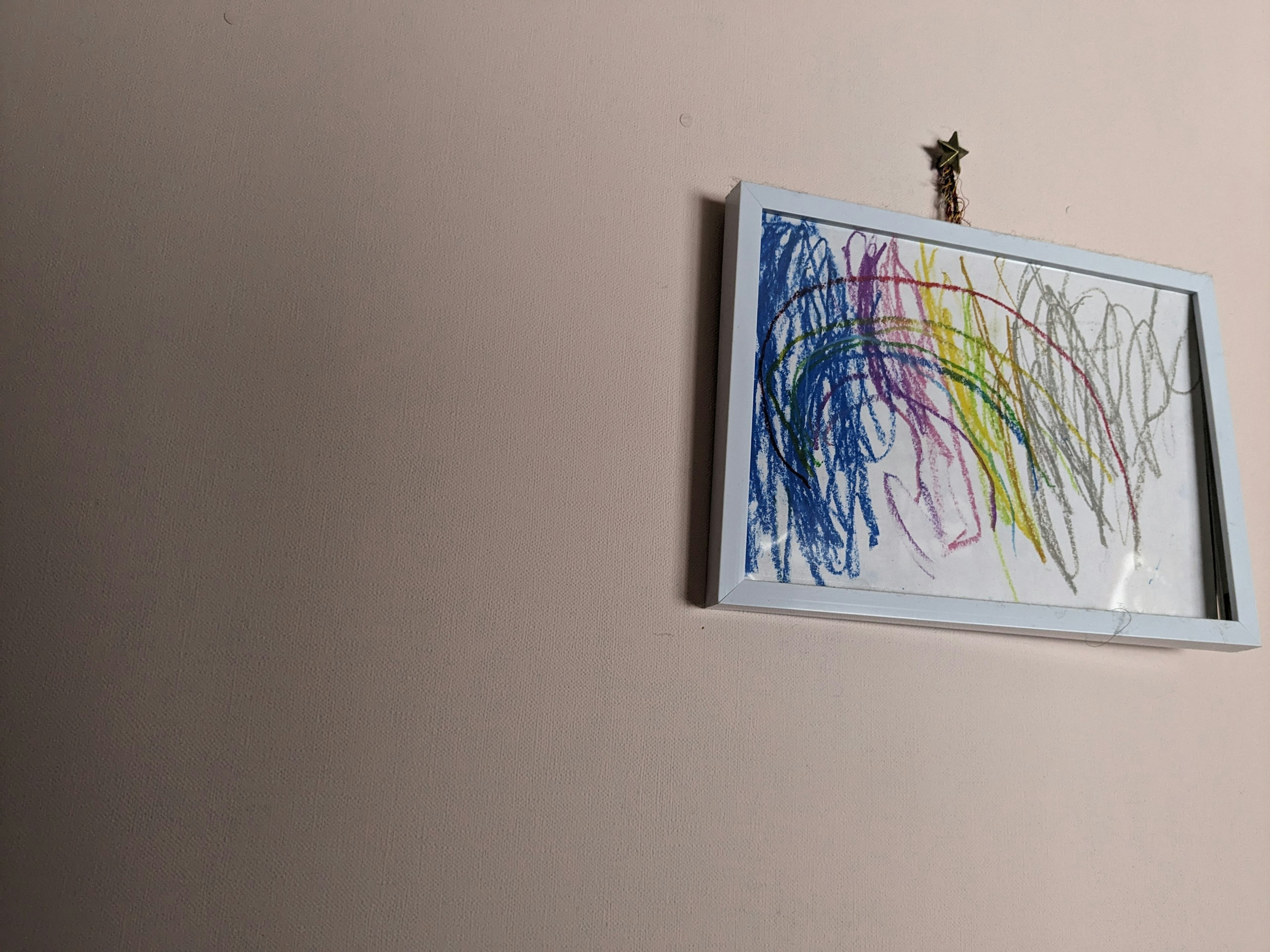 Child's drawing featuring blue and green lines in a white frame