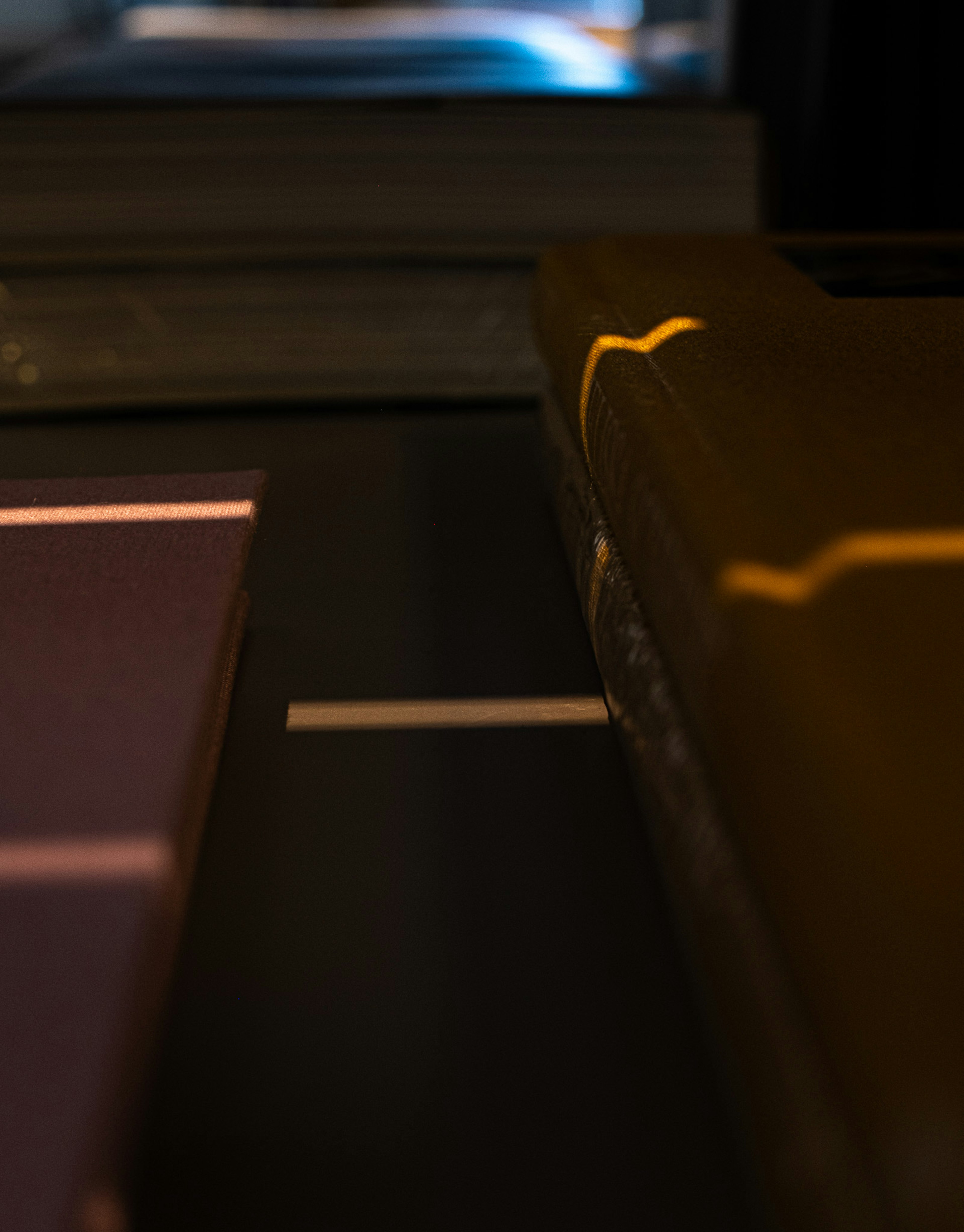 Close-up image of book spines with distinctive light reflections