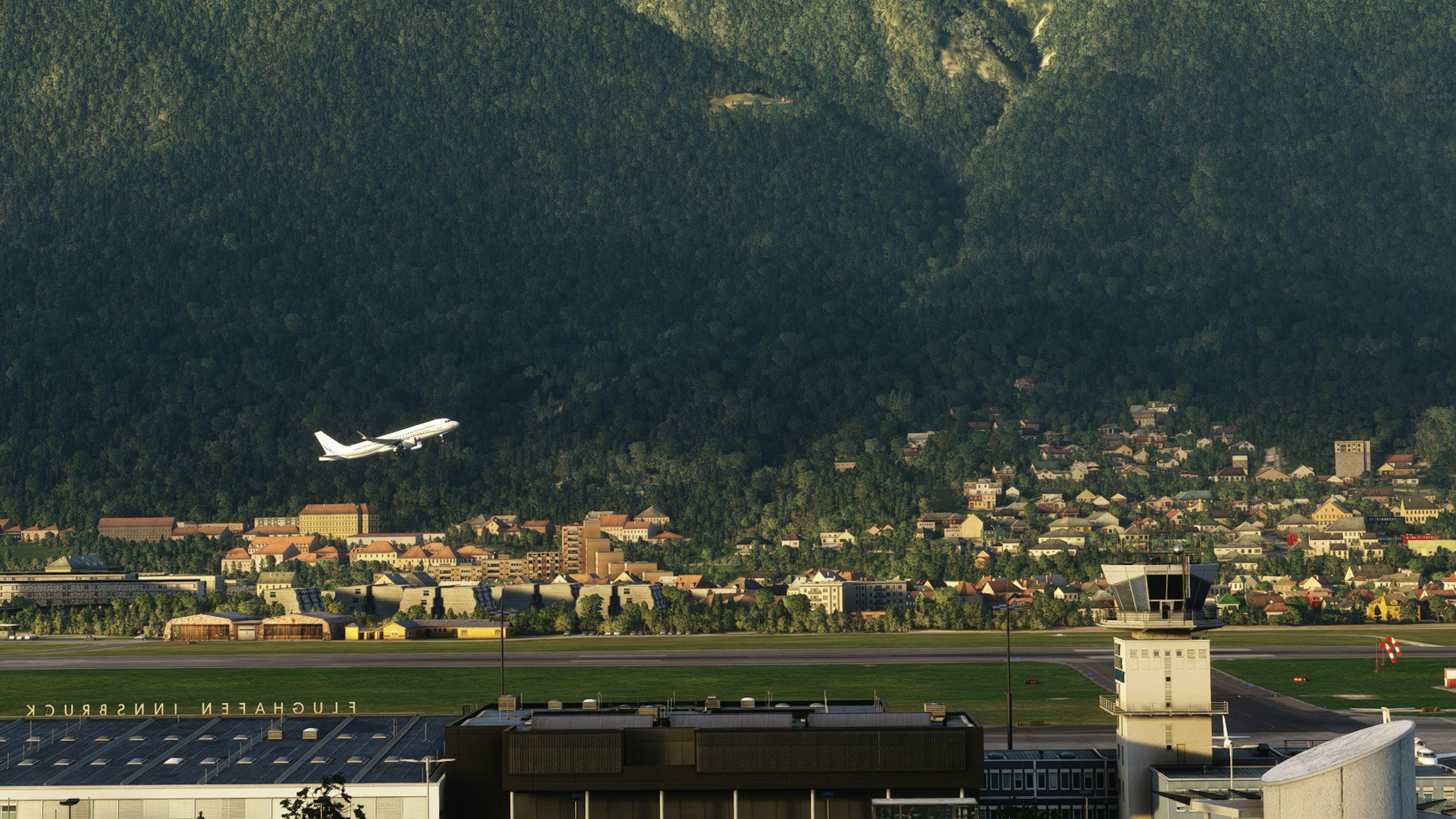 Flugzeug startet mit Bergen im Hintergrund