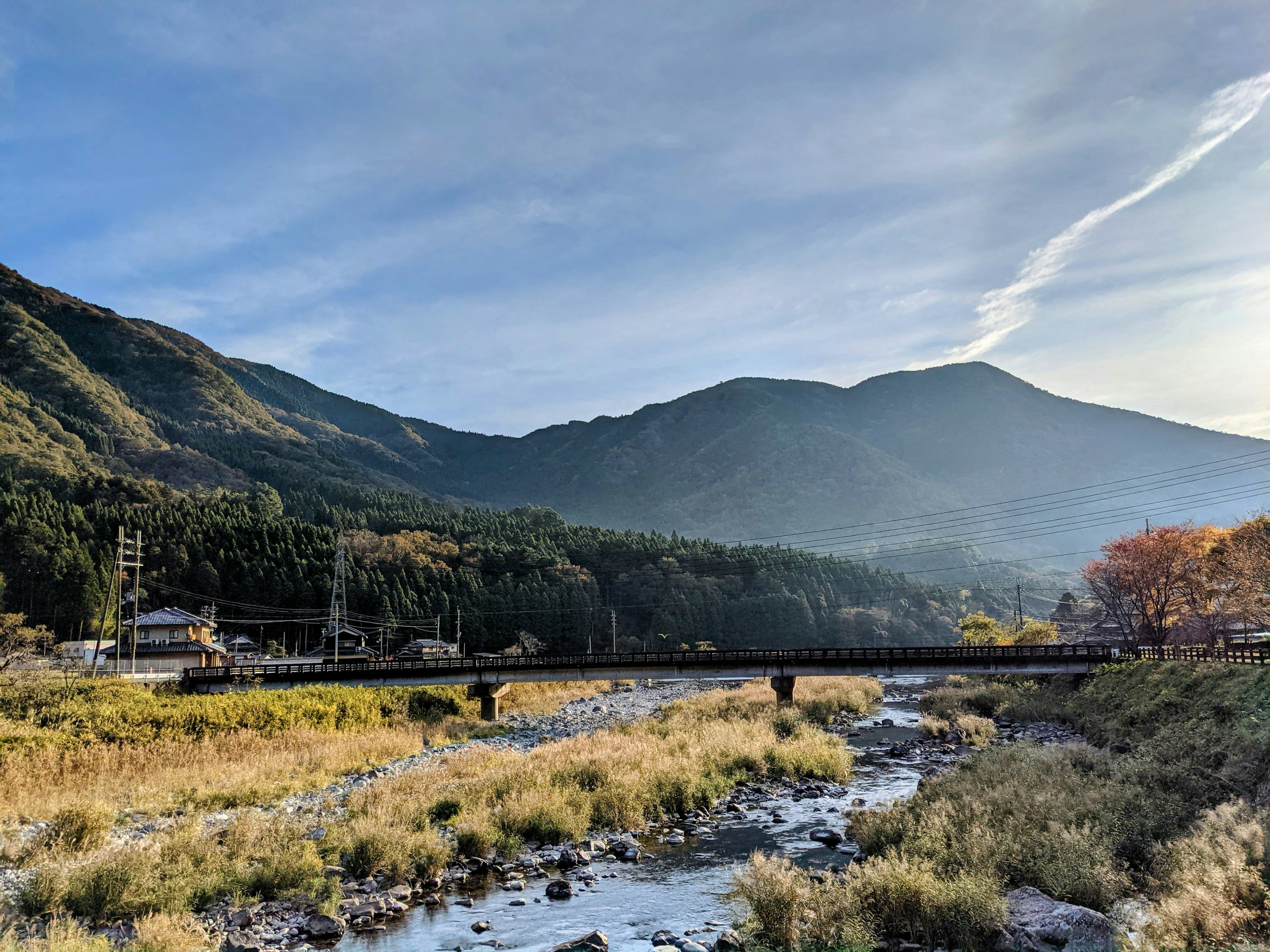 Scenic view of mountains and a river with a bridge