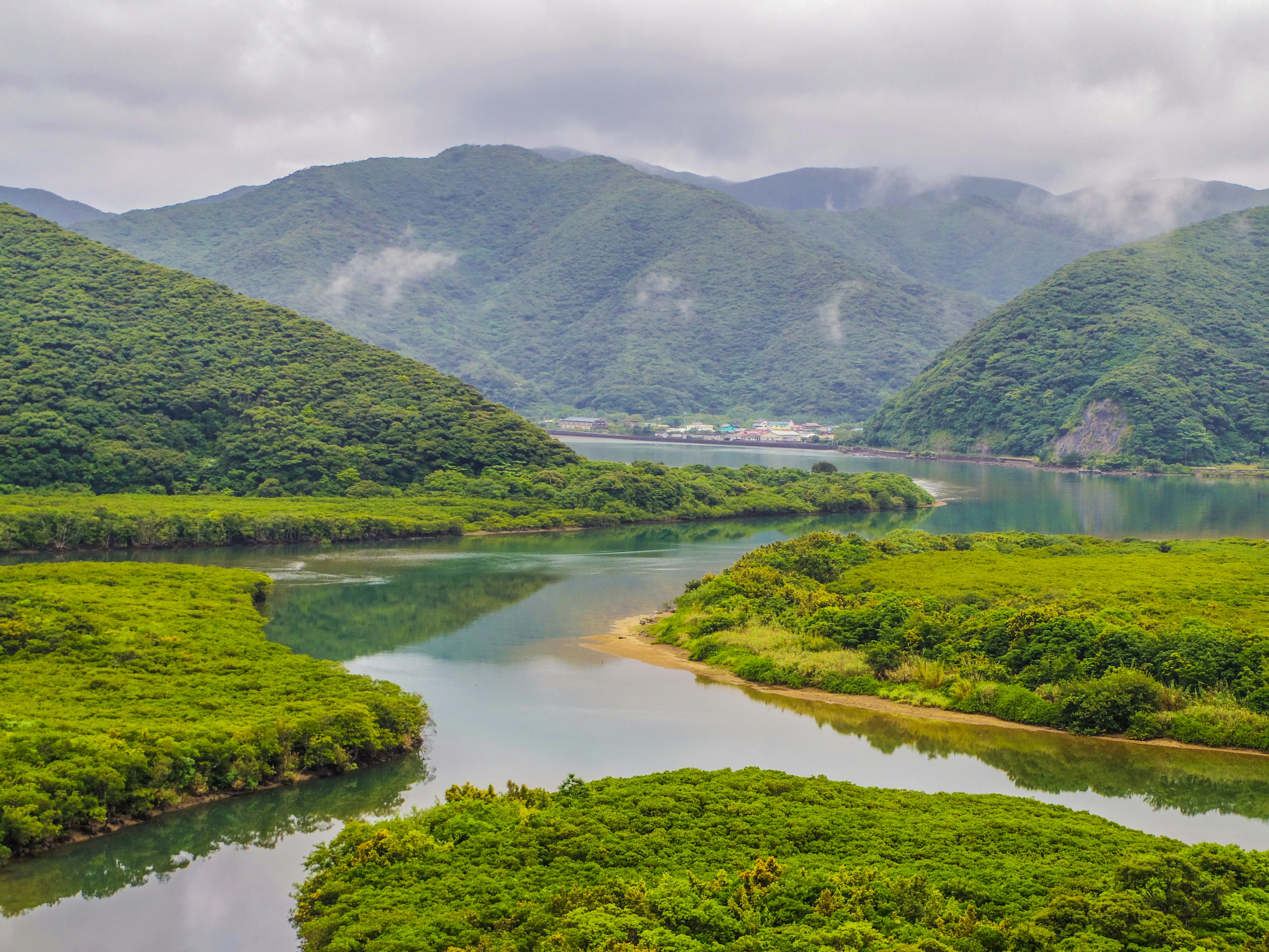 Lush river landscape surrounded by mountains