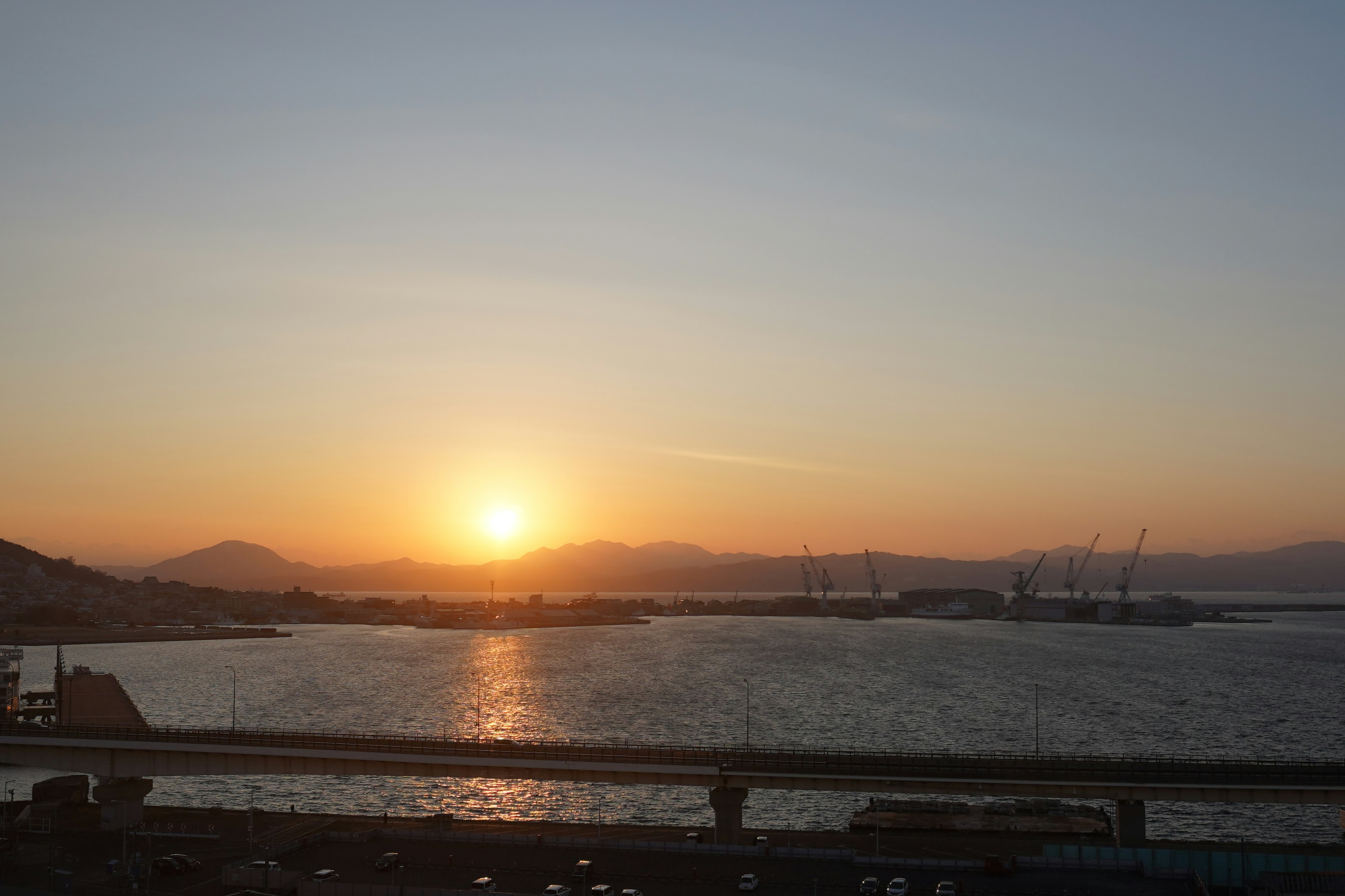 Puesta de sol sobre el mar con superficie de agua tranquila