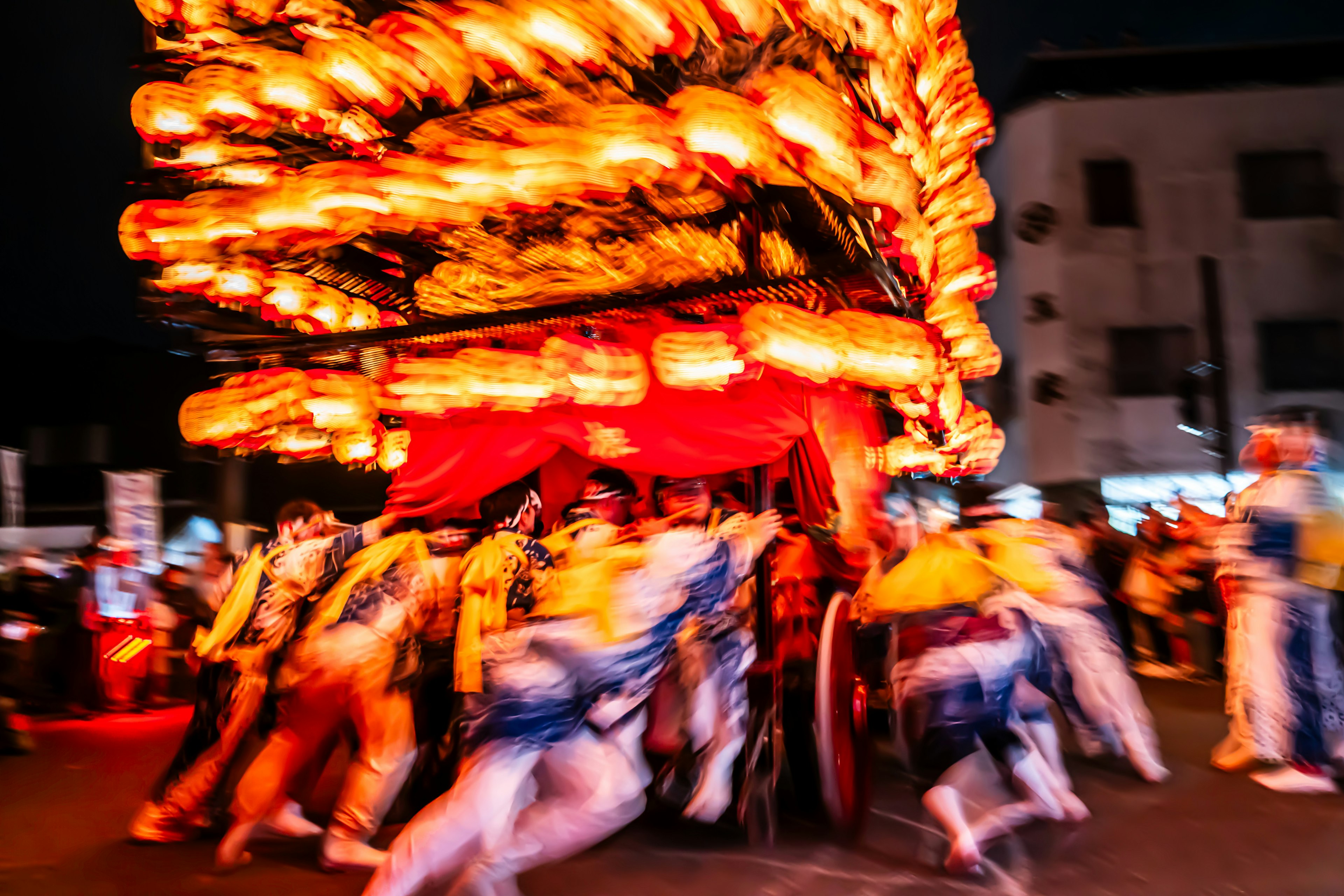 Crowd carrying colorful lanterns during a night festival