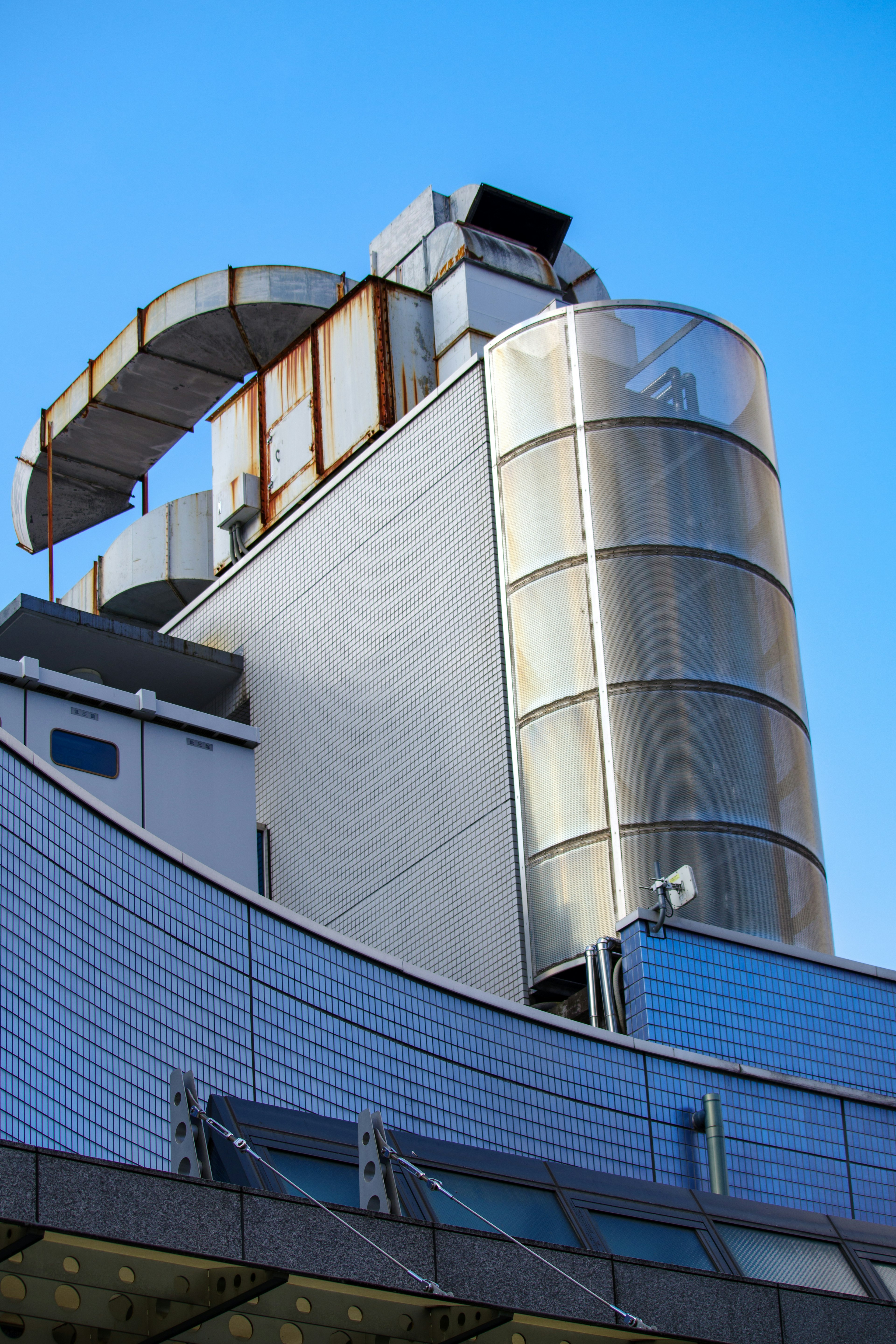 Modern building with metallic structure against blue sky