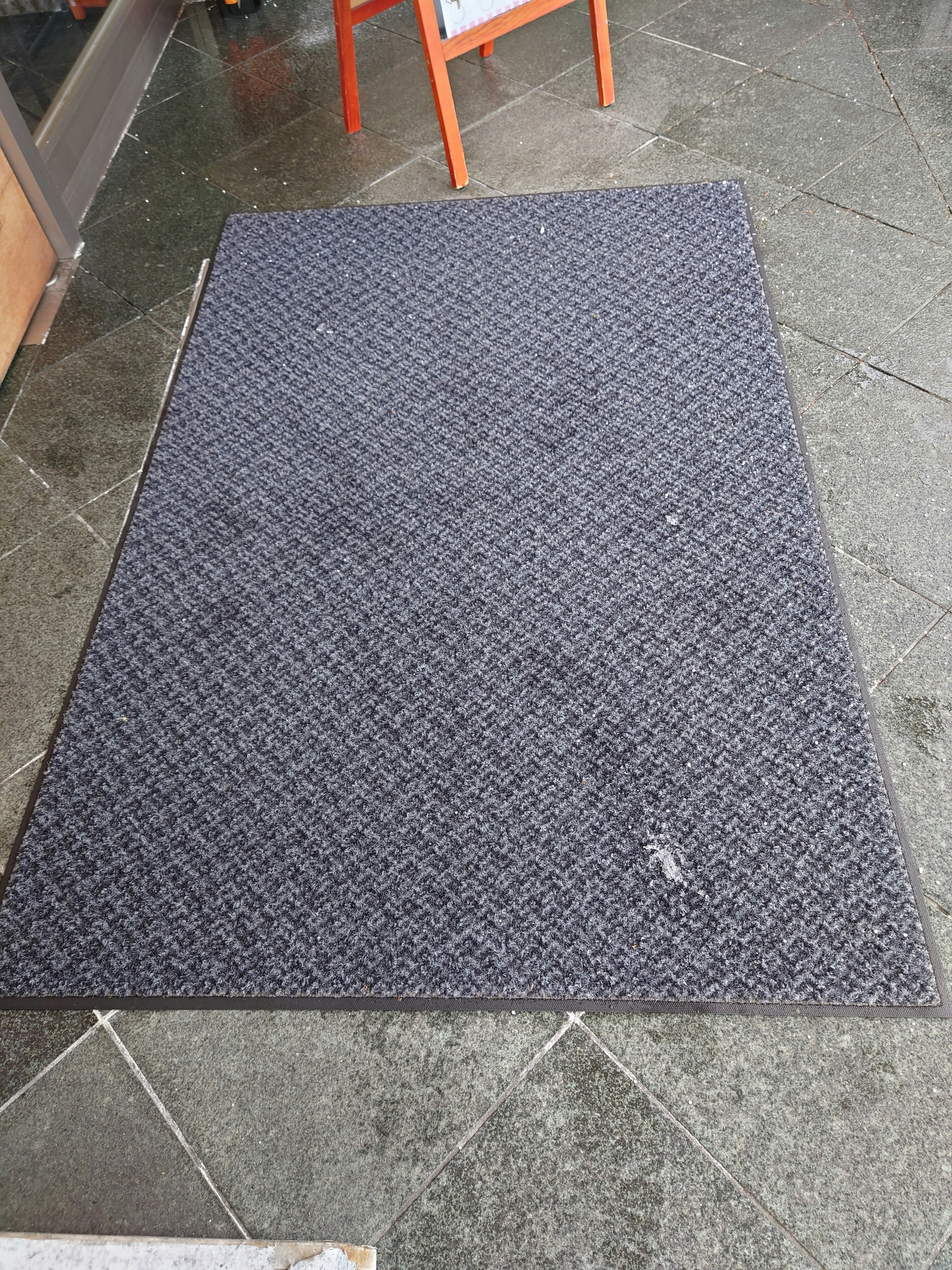 Black mat placed on a stone floor