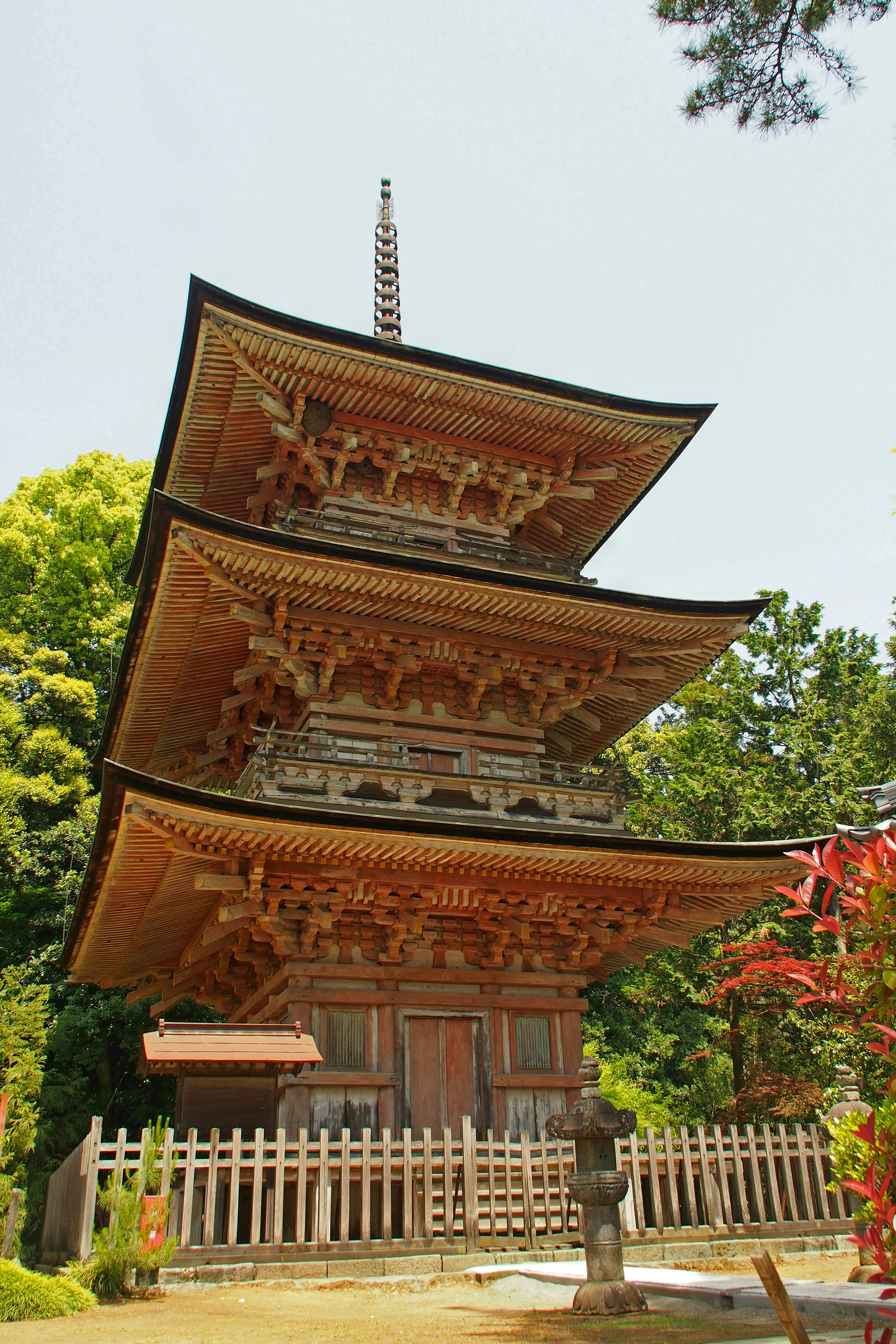 A beautiful three-story pagoda surrounded by greenery