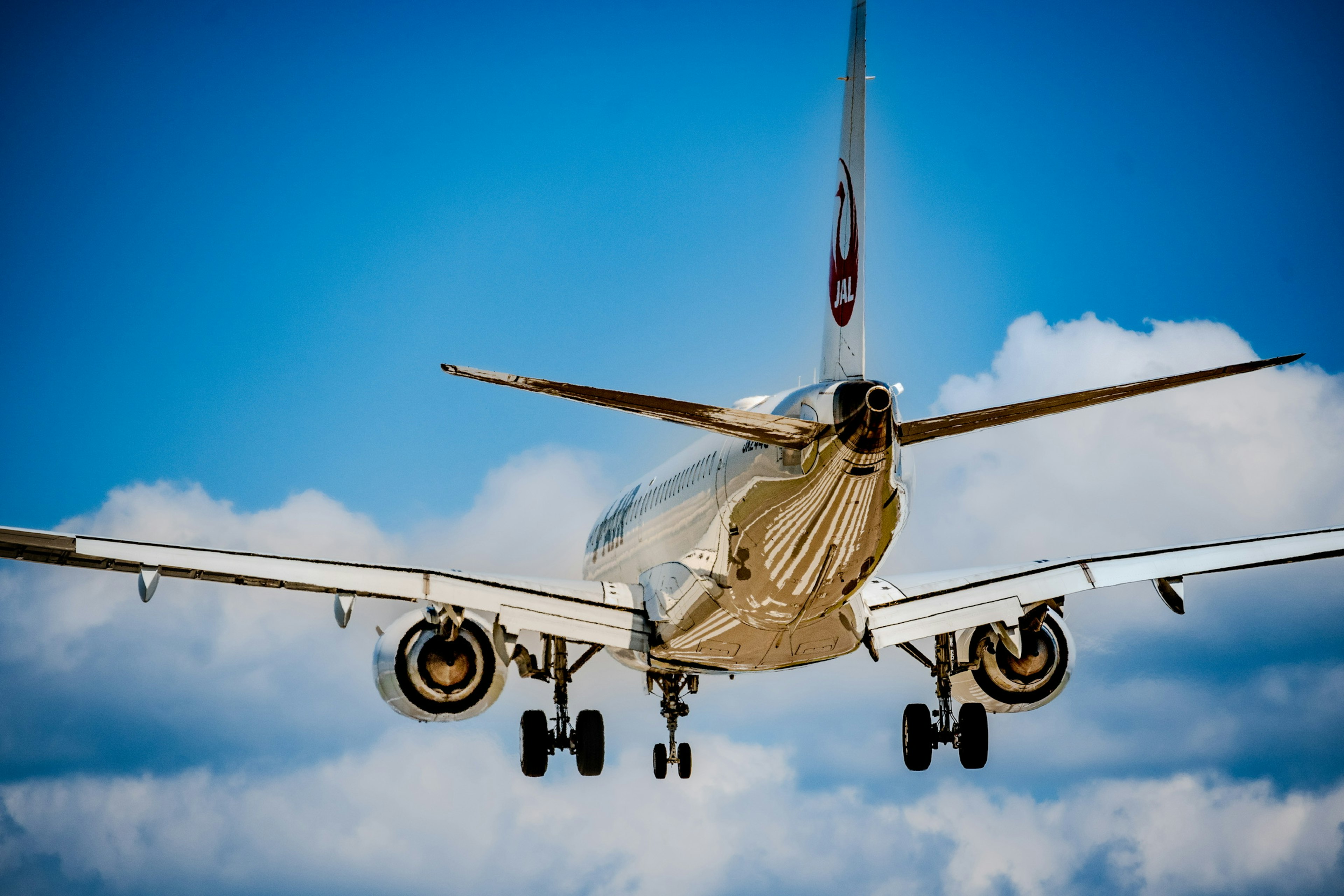 Passenger airplane landing under a blue sky