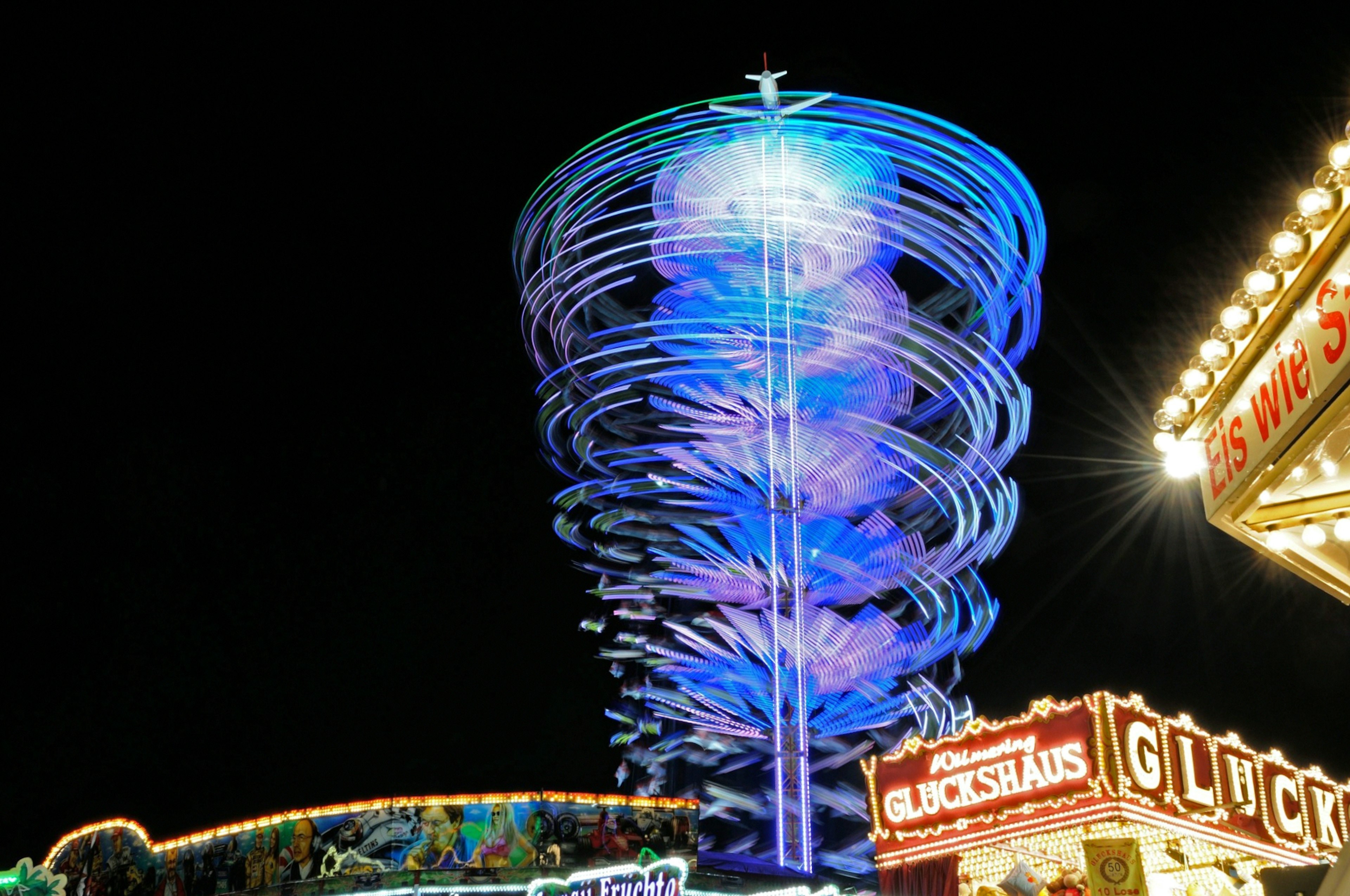 Spinning light attraction at night in an amusement park