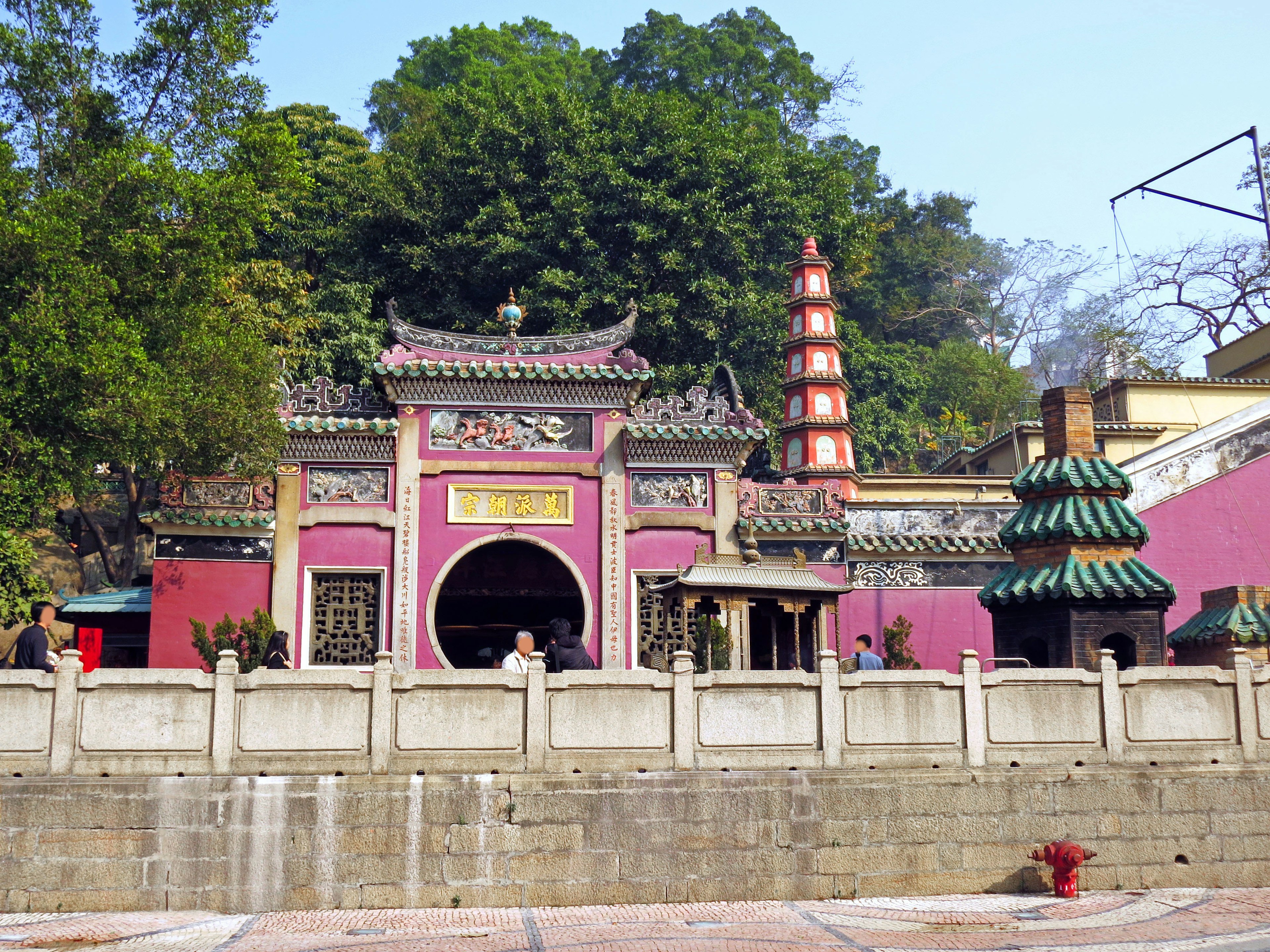 Extérieur vibrant d'un temple entouré de verdure avec des éléments architecturaux chinois traditionnels