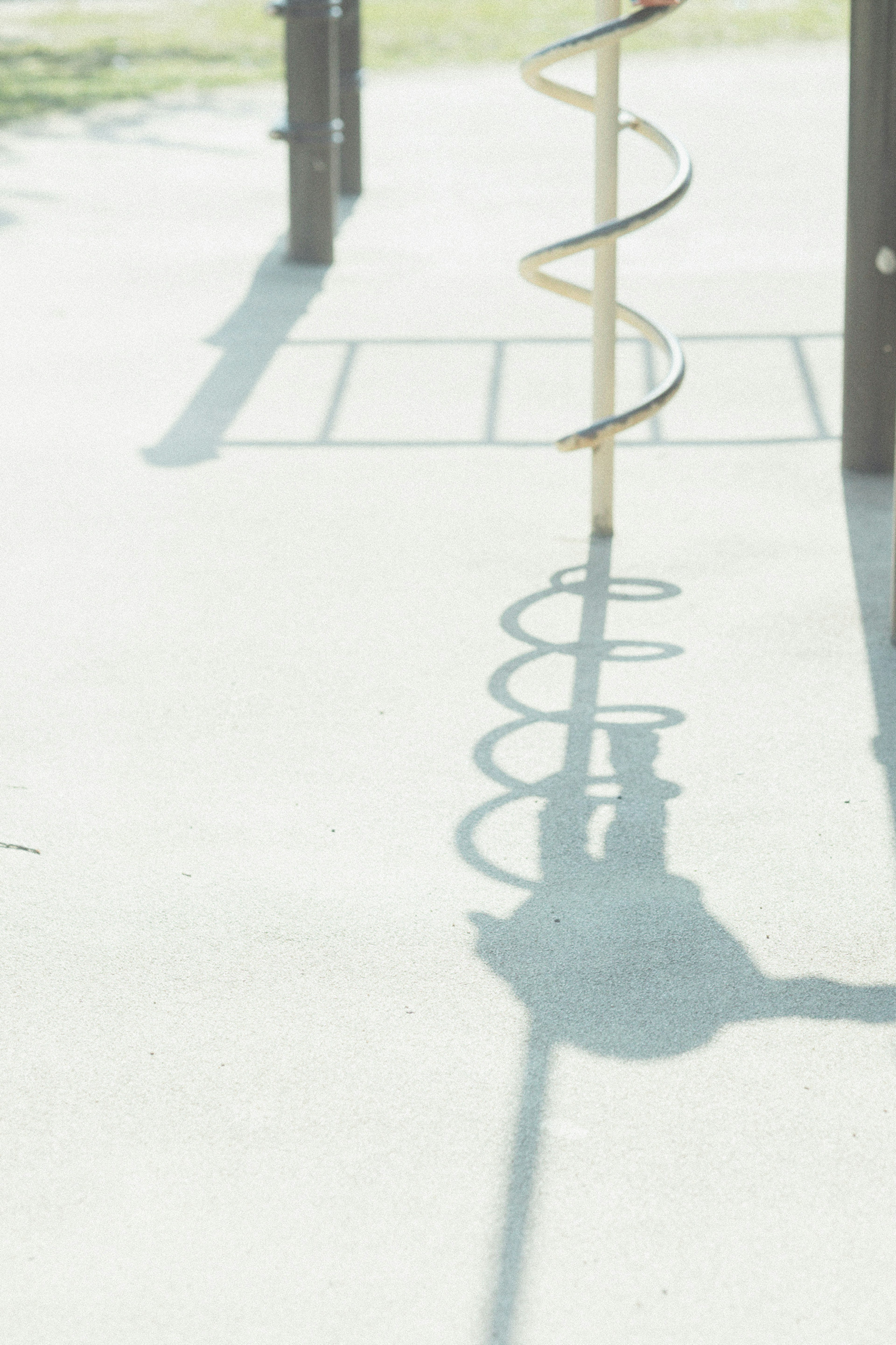 Shadow of a spiral slide in a playground