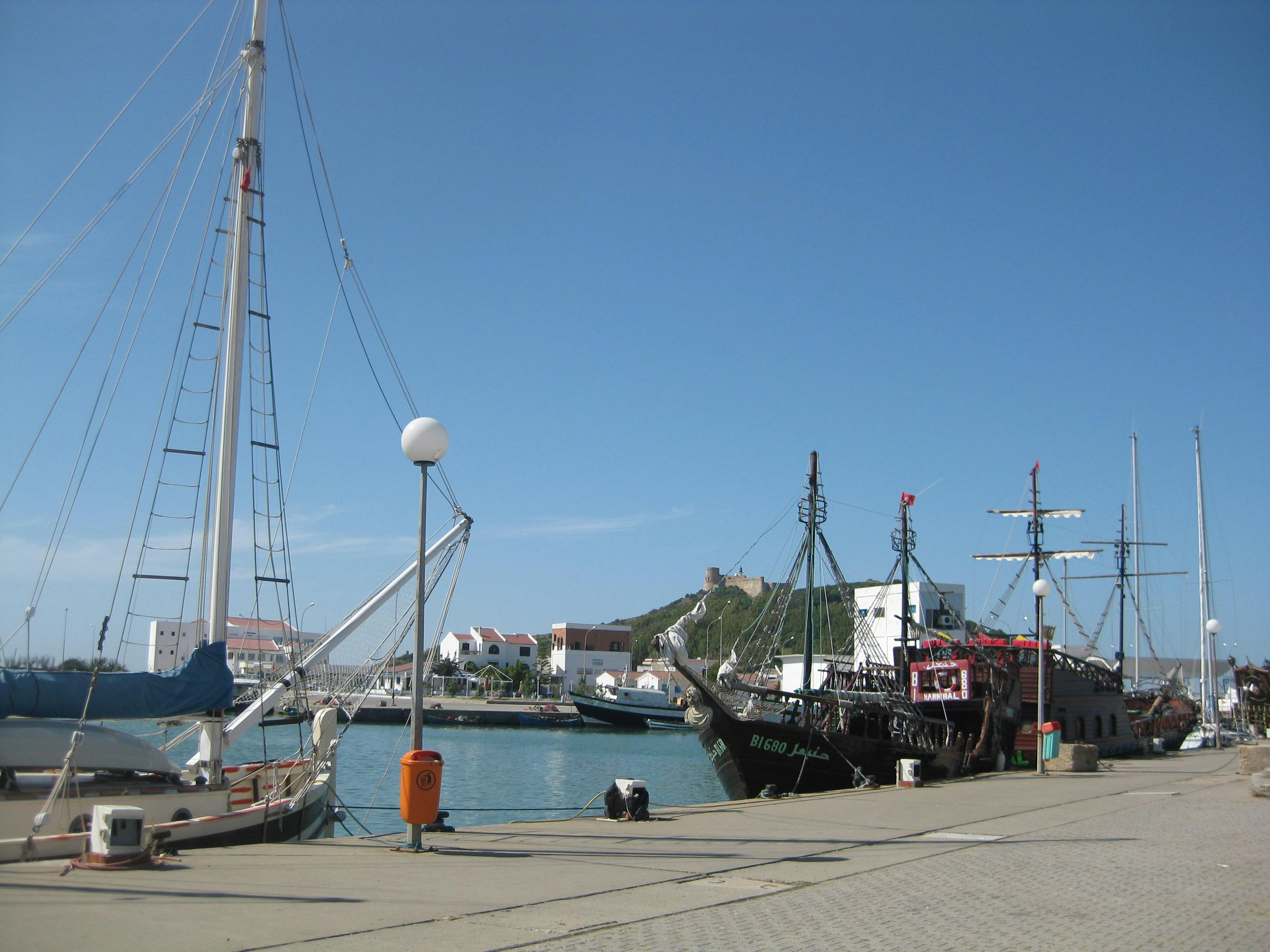 View of boats docked at the harbor with a clear blue sky