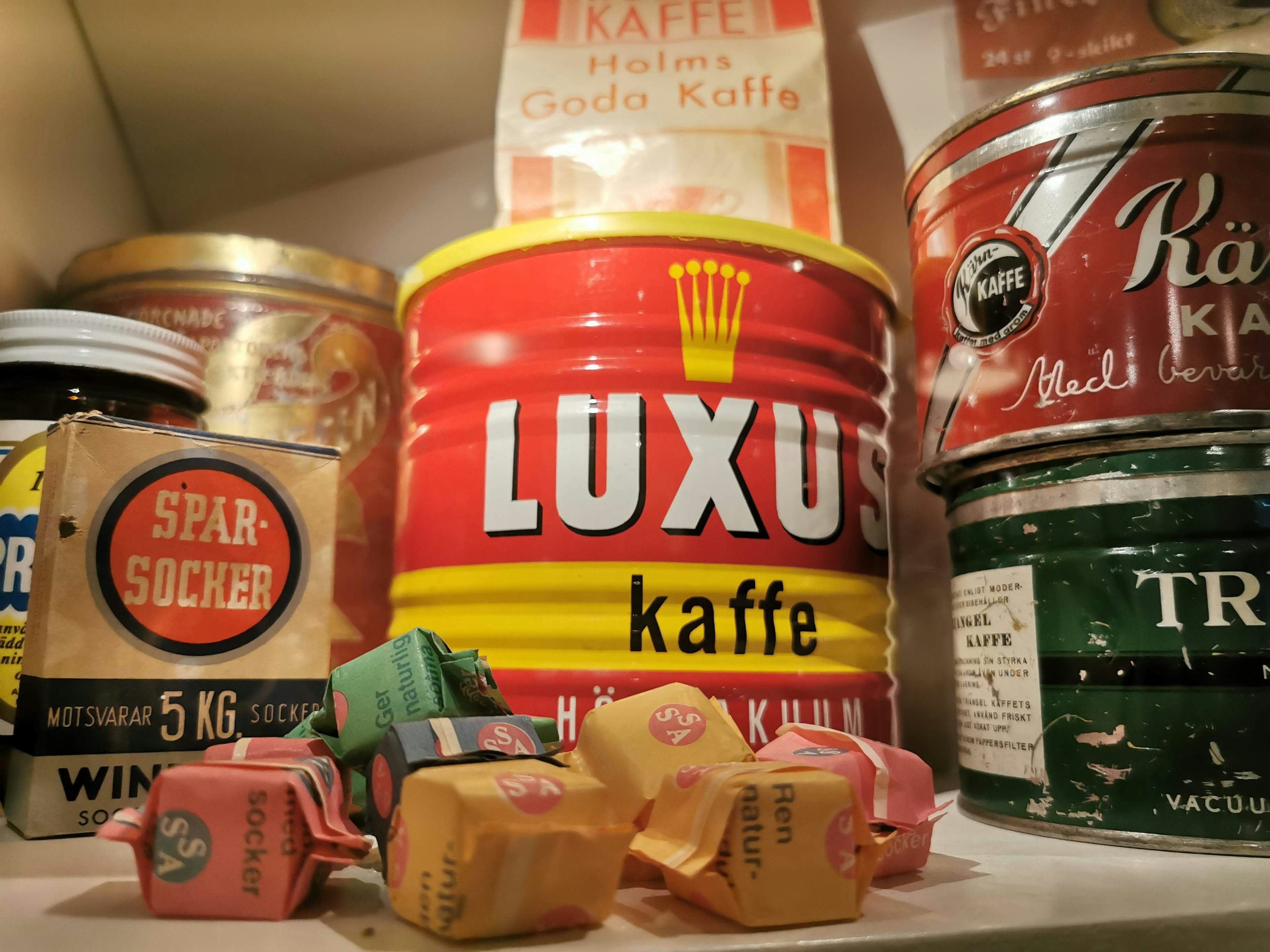 Colorful coffee cans and candies on a vintage shelf