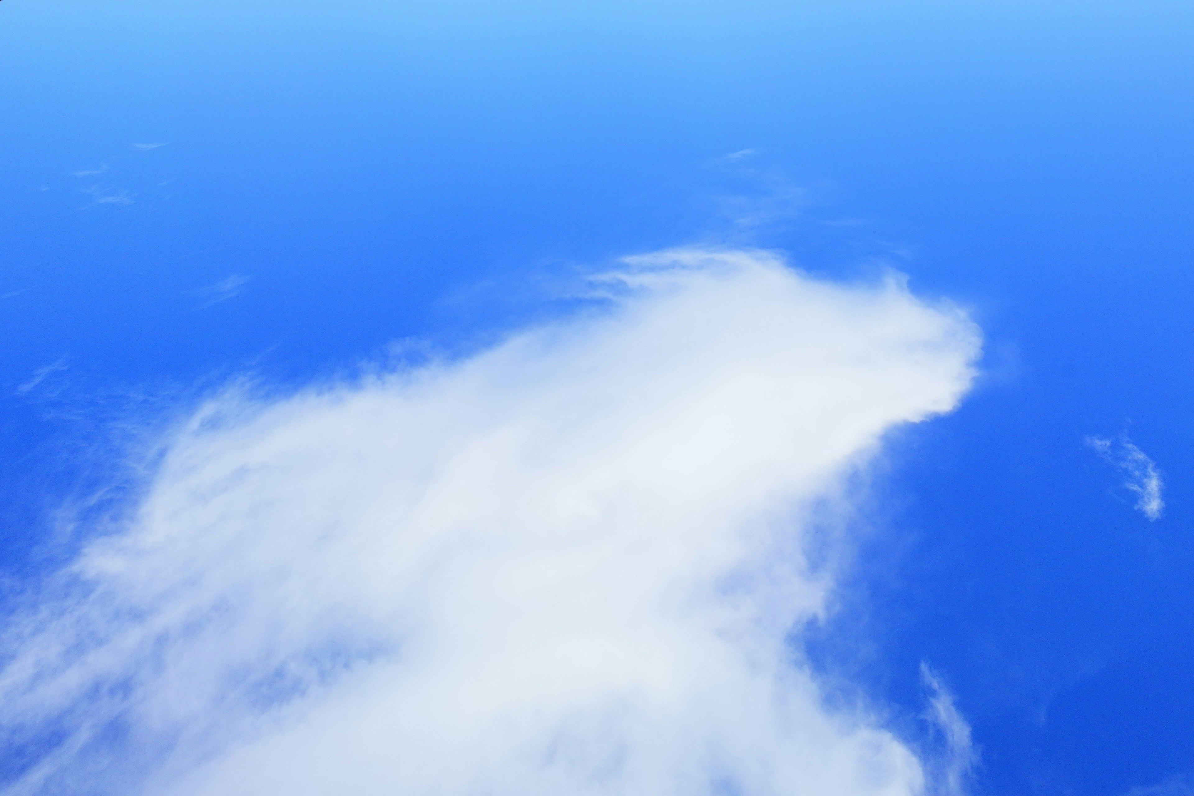 White clouds covering blue ocean expanse