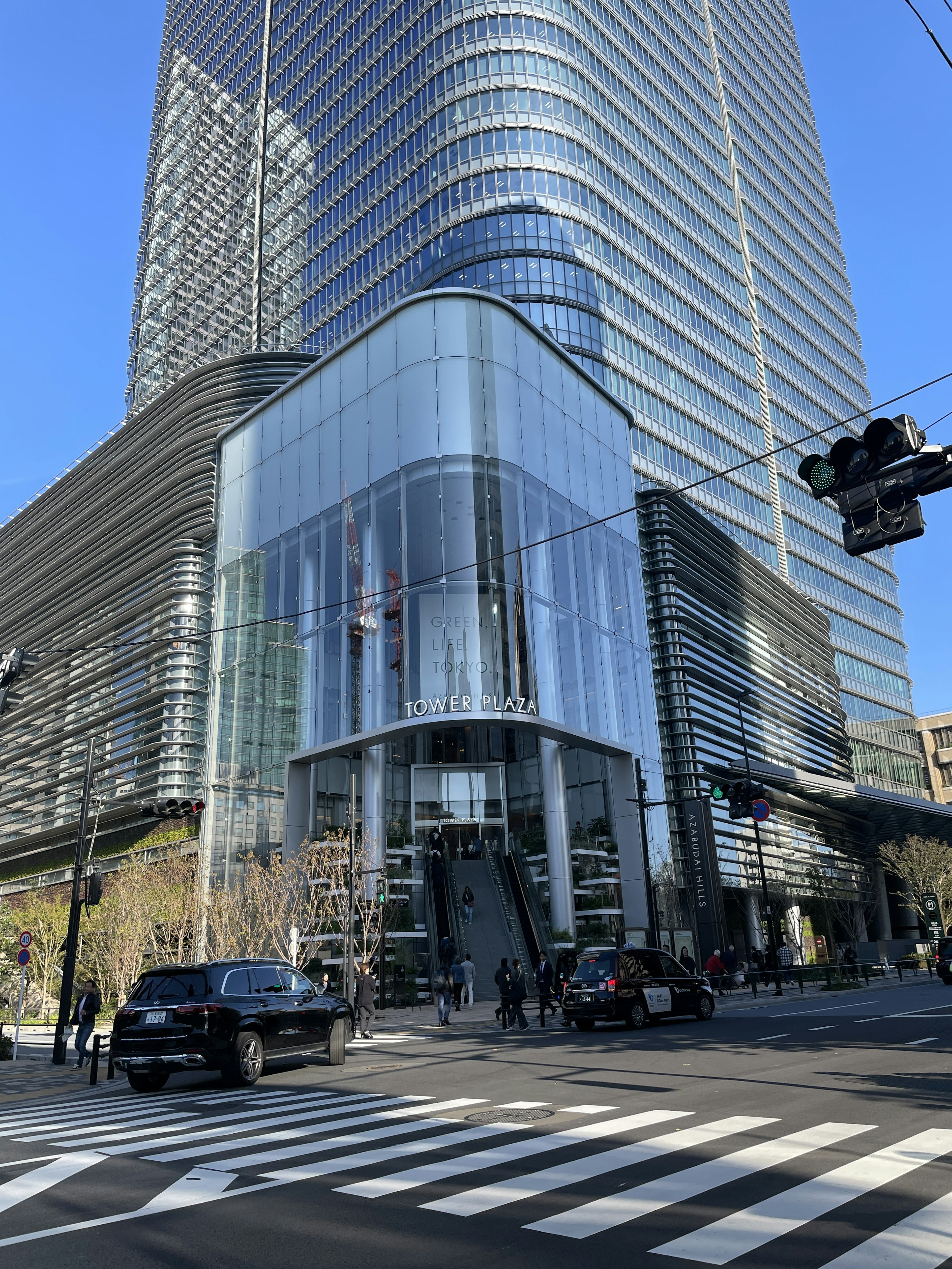 Modern glass facade of a skyscraper with a striking entrance