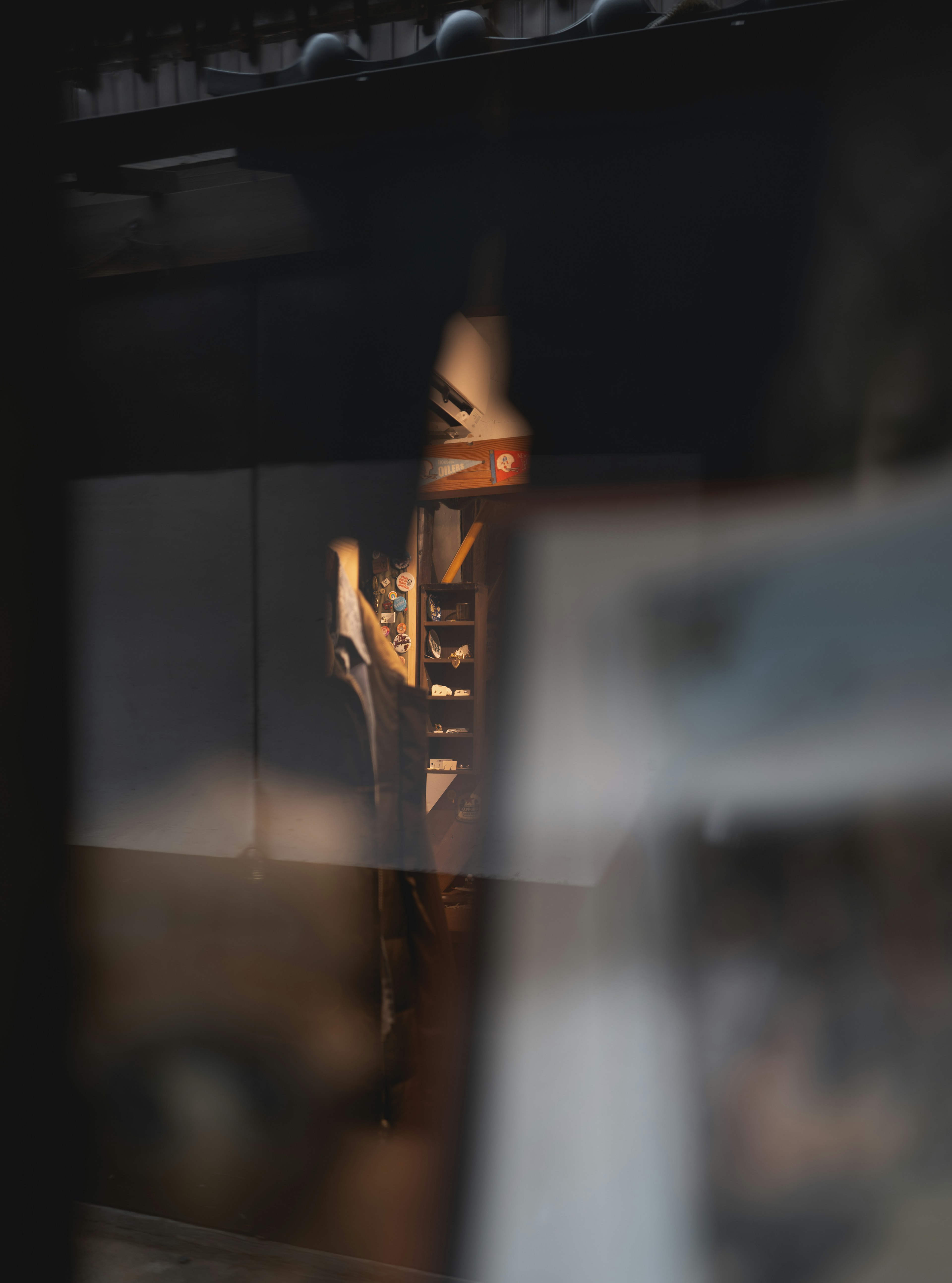 Wooden chair and part of a wall reflected in a dark background