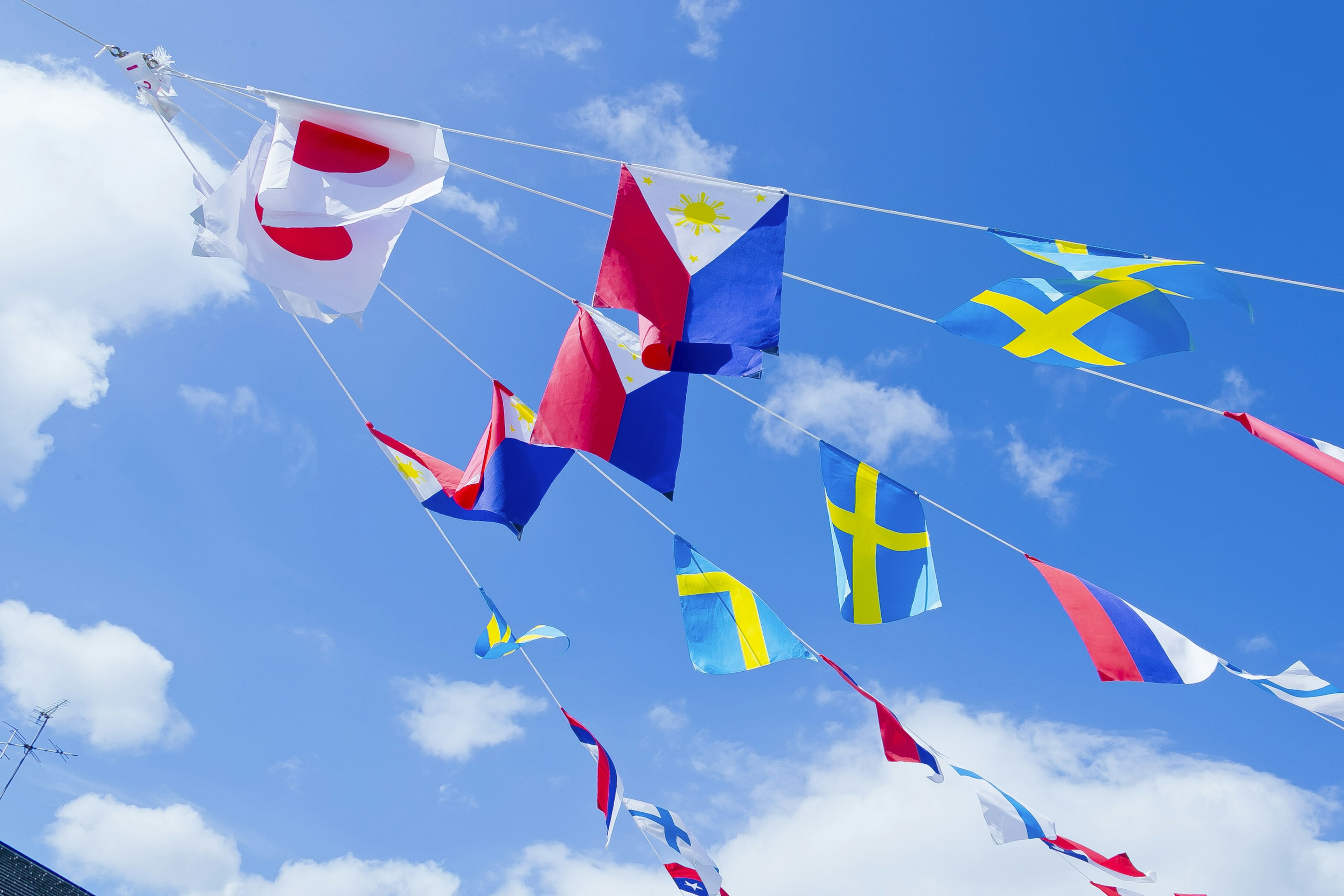 Garland of national flags under a blue sky