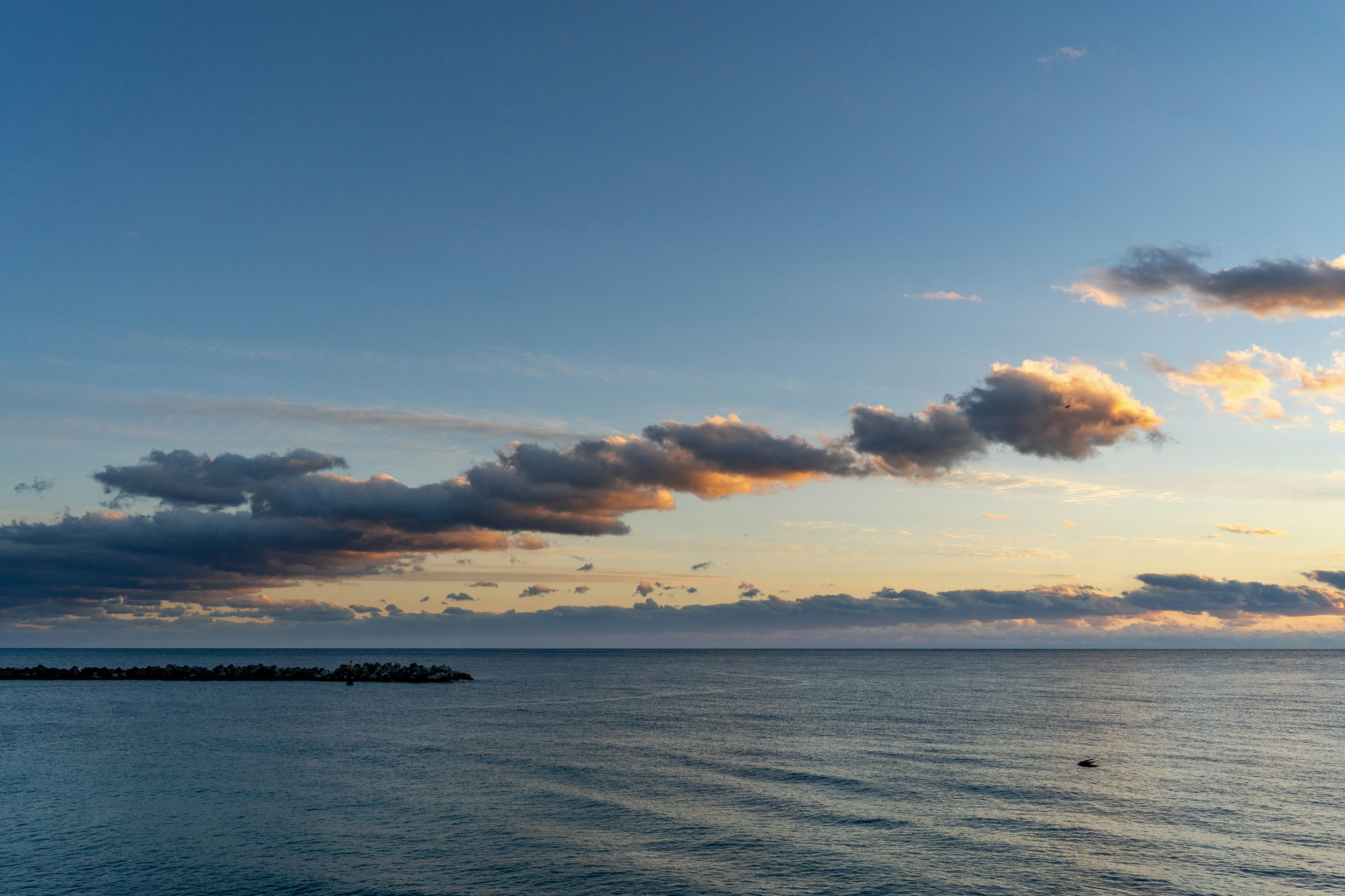 Serene seascape with blue sky and floating clouds