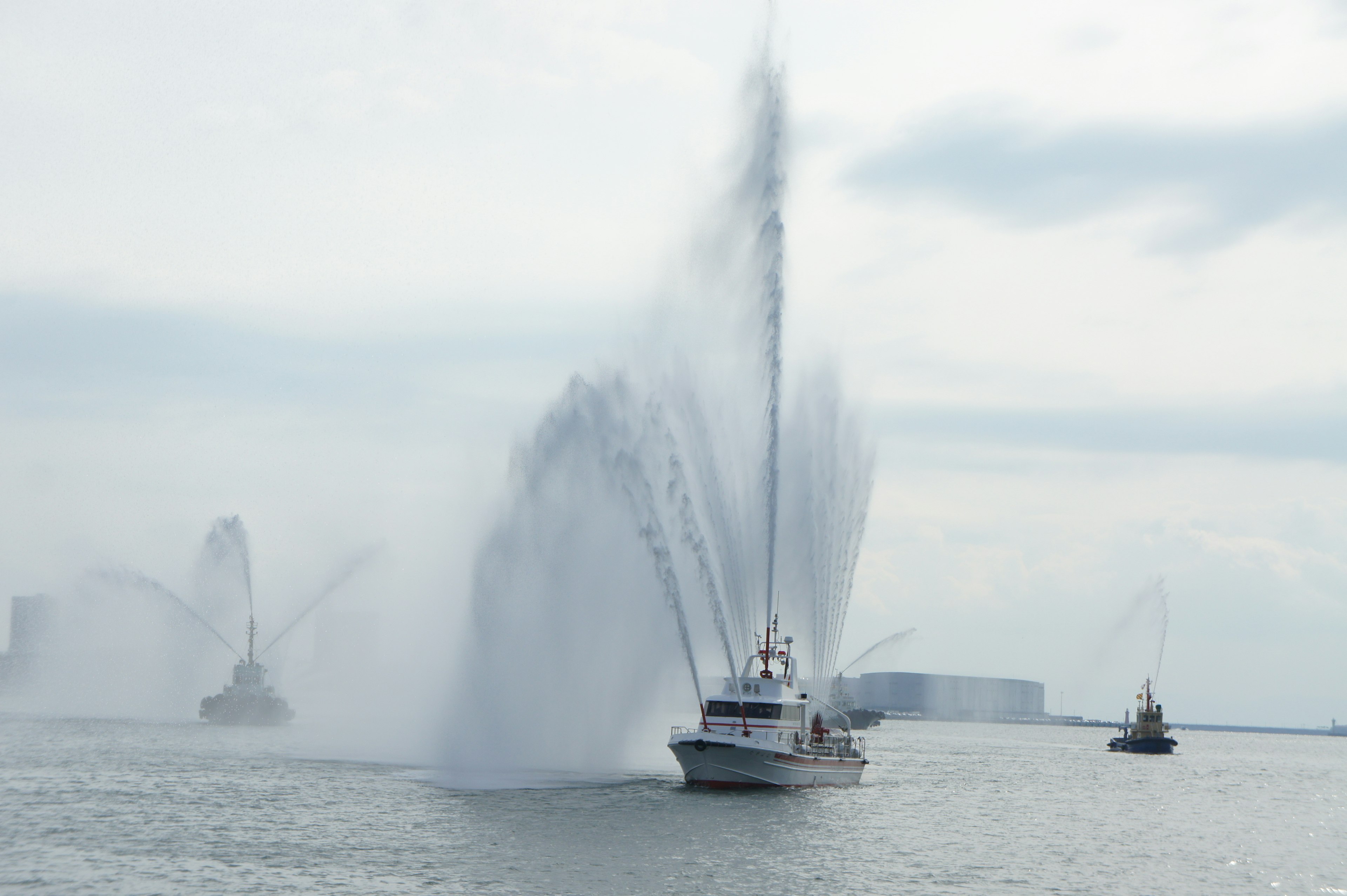 A boat creating water spray as it moves through the sea