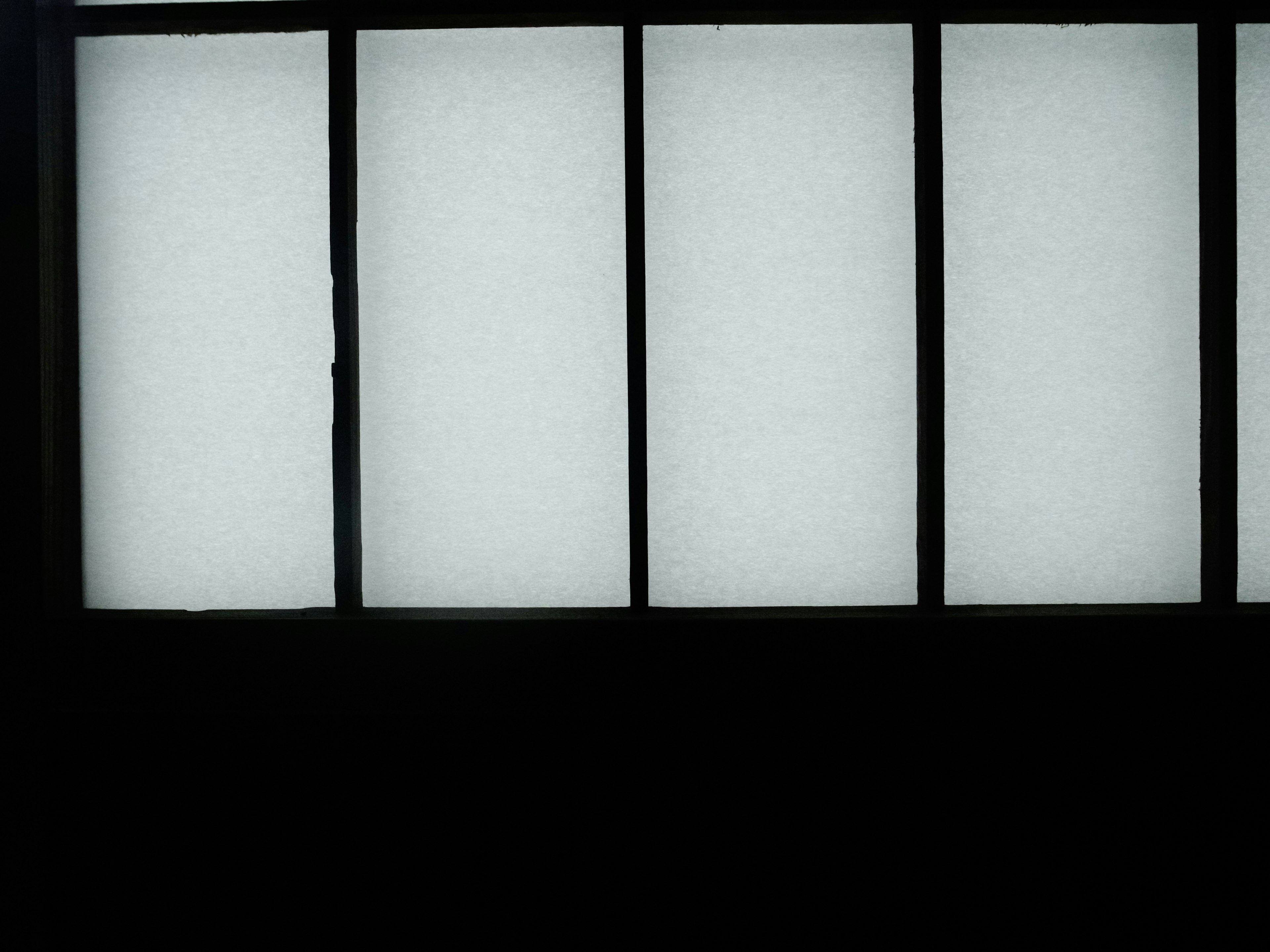 Four illuminated panels against a black background