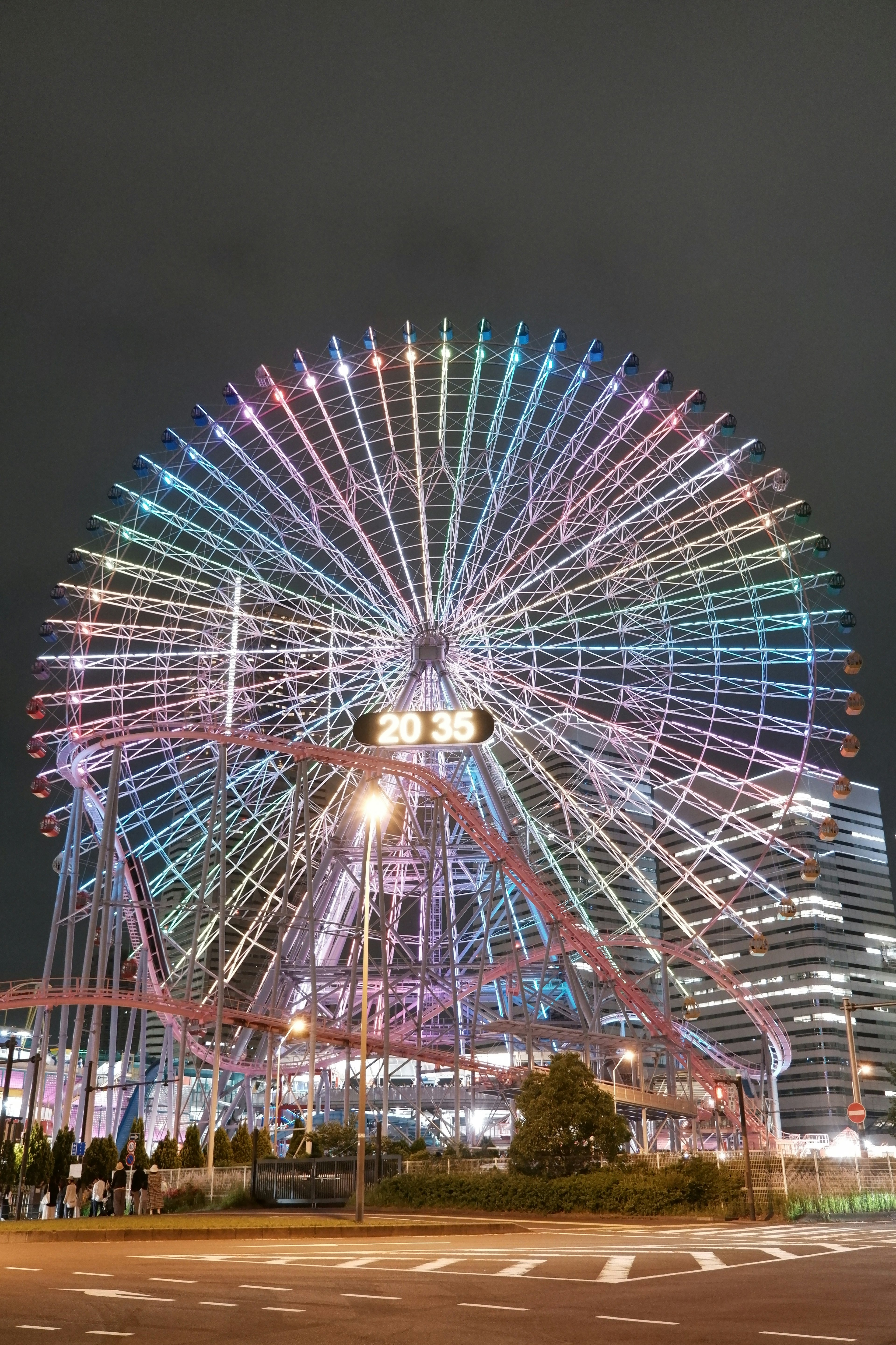 A colorful illuminated Ferris wheel at night