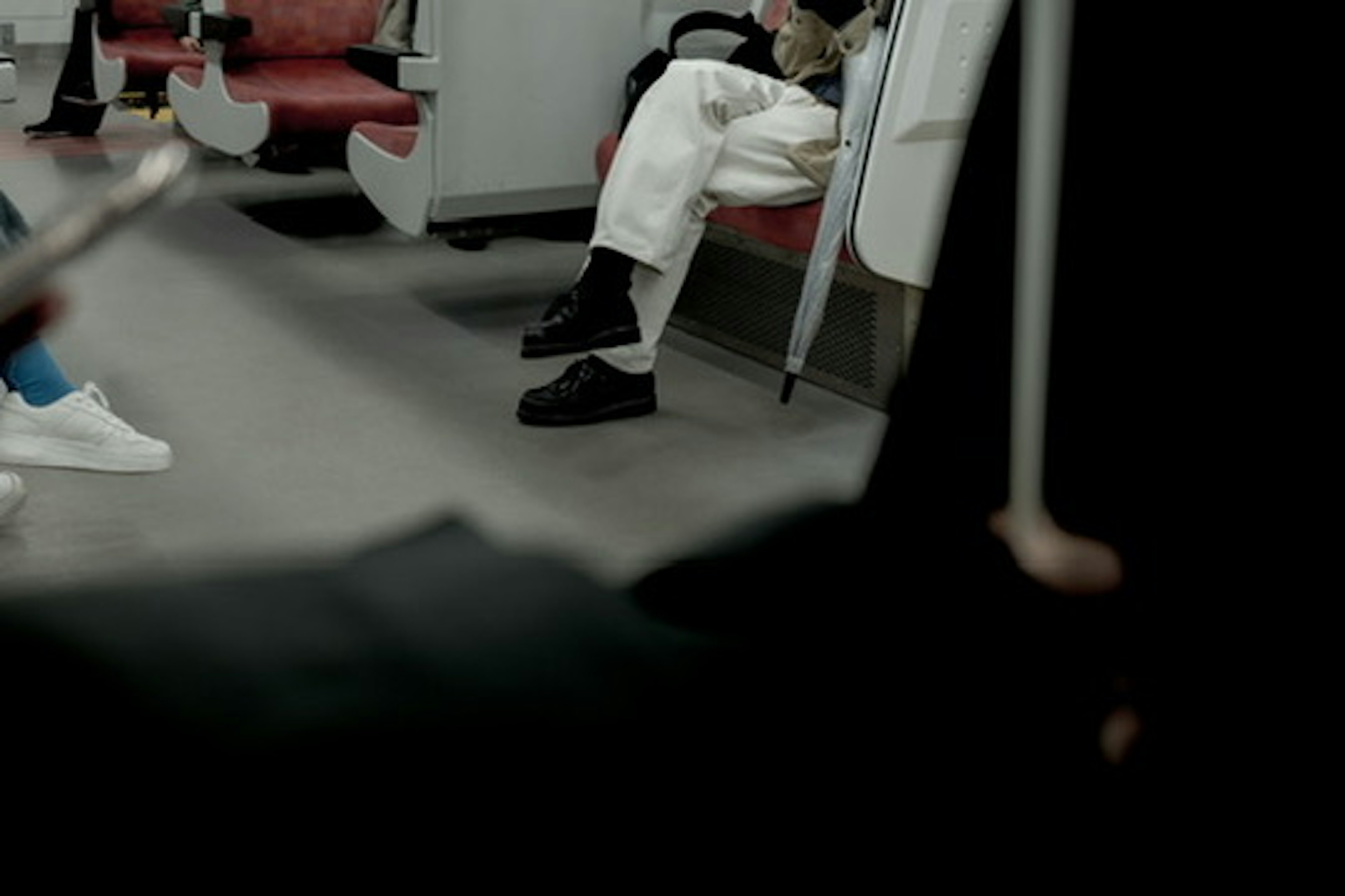 Scene showing people's feet in a subway car