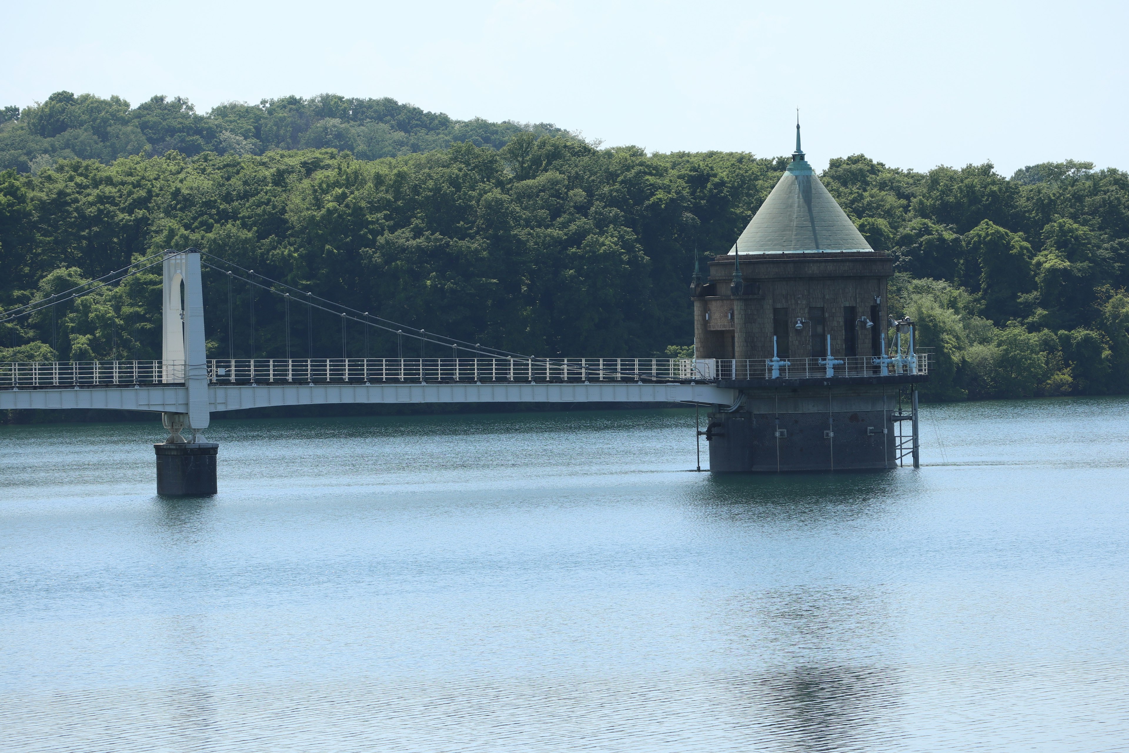 Scenic view of a beautiful structure on a lake with a bridge