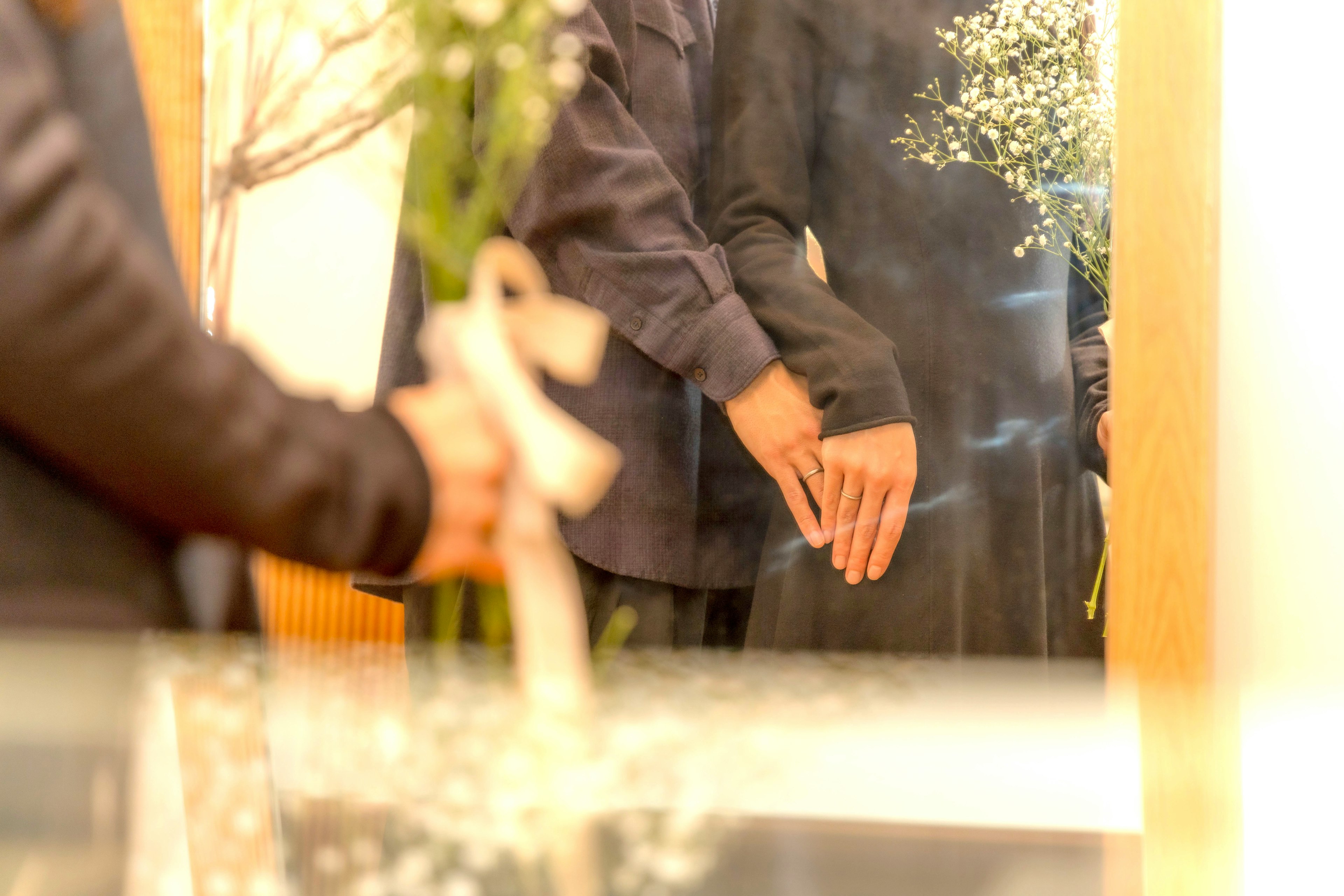 A scene of people holding flowers and embracing