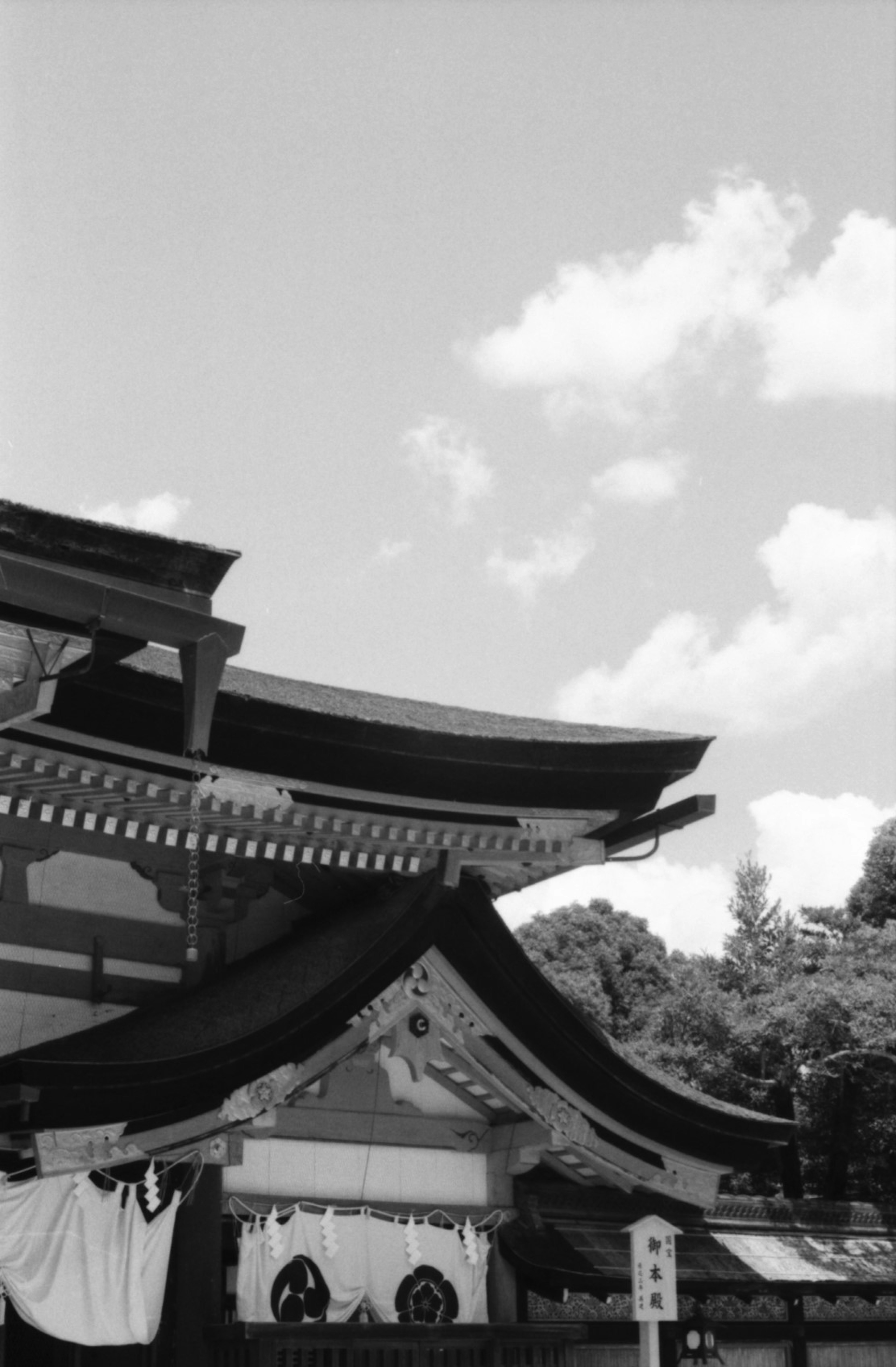 Black and white traditional Japanese shrine roof with clouds